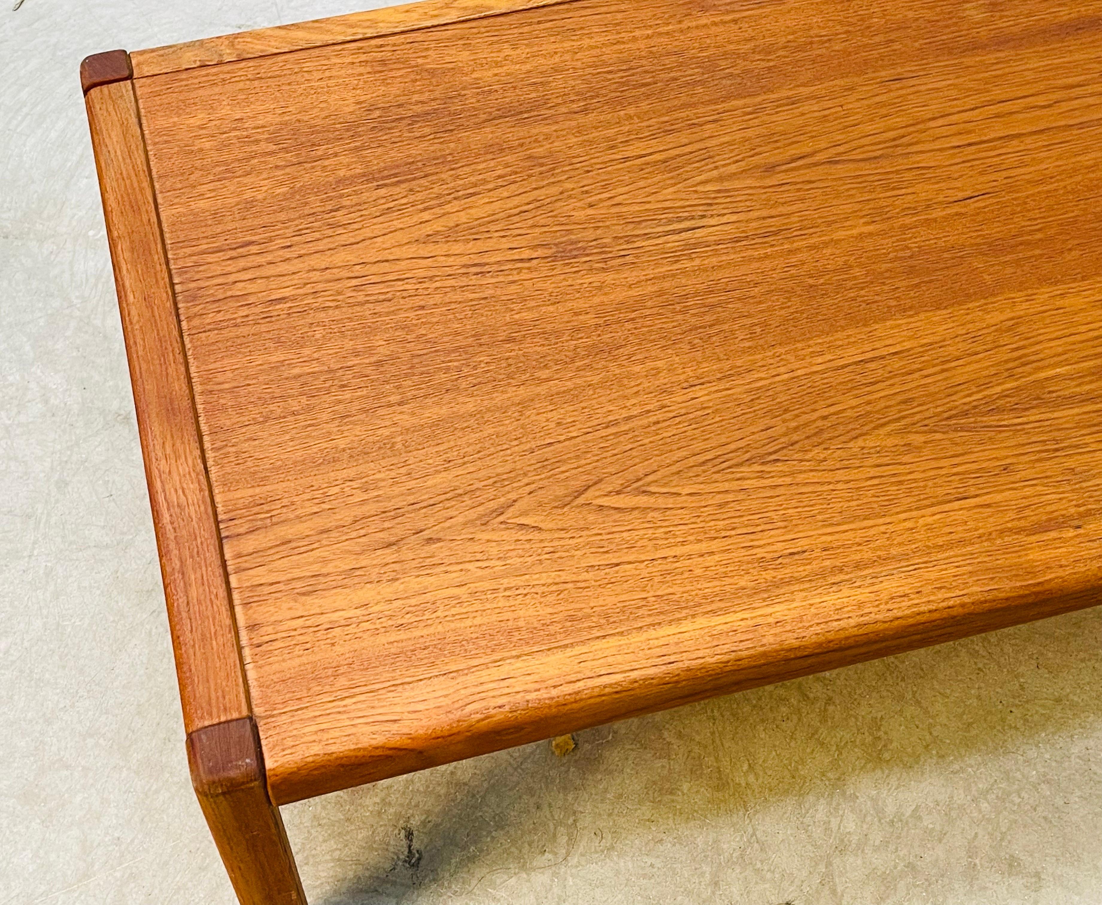 Vintage 1970s rectangular solid teak wood coffee table. Solid and sturdy the table has square legs. The table is in newly refinished condition. Marked Denmark.