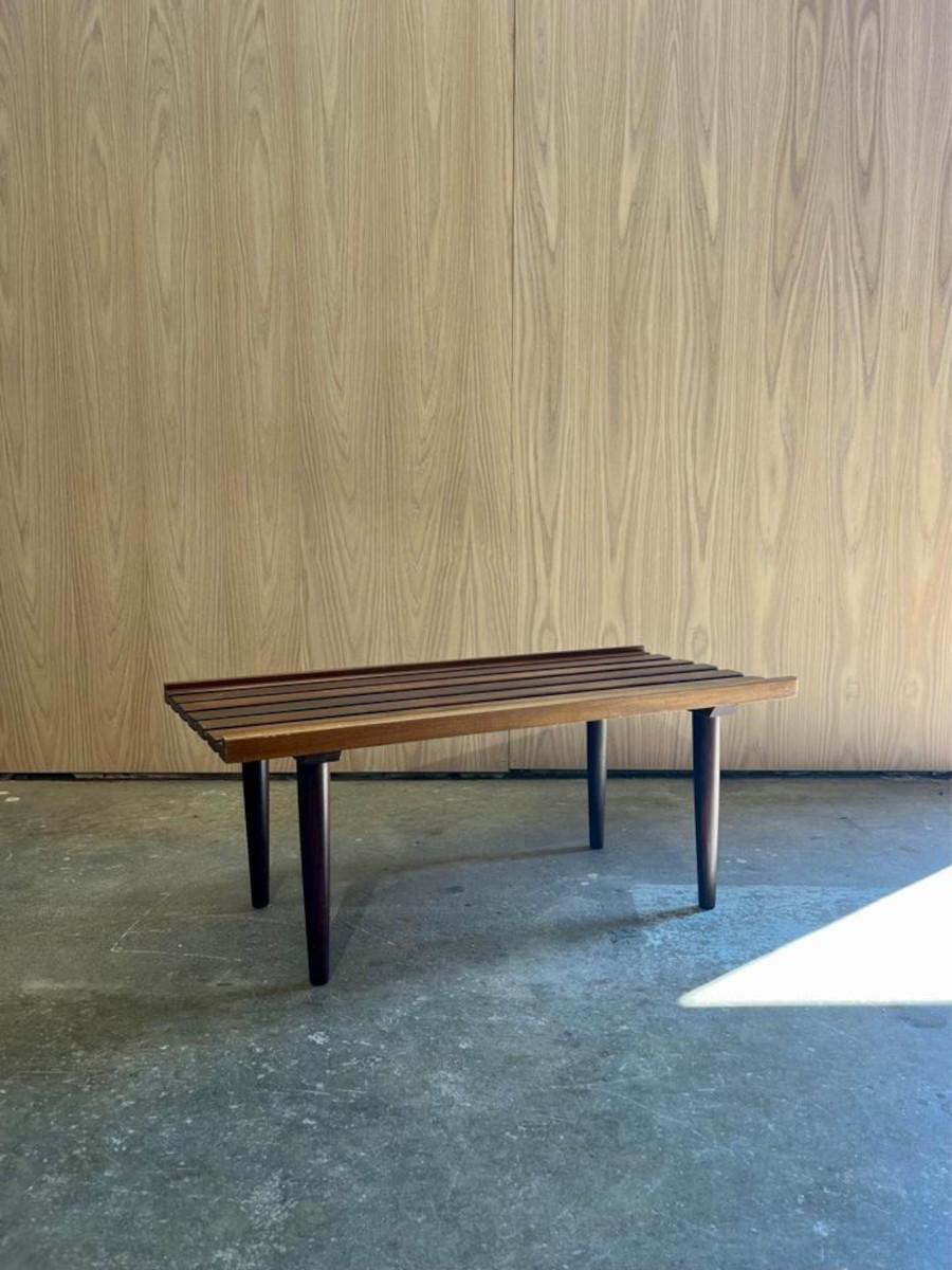 Introducing this 1970s teak slat coffee table, crafted from solid Afrormosia wood. Its sleek design and slatted surface exude mid-century charm, while its compact size is perfect for small spaces.

36
