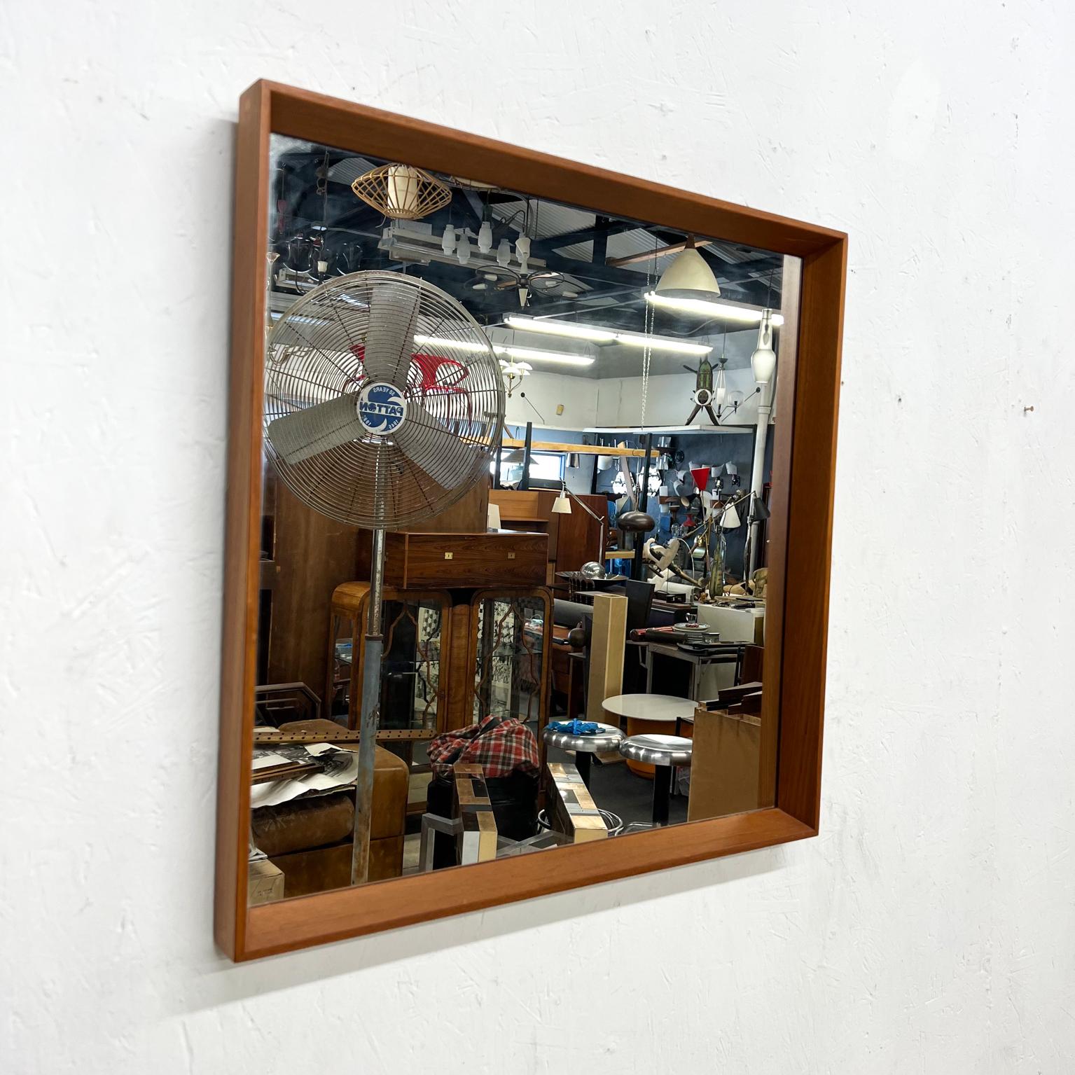 Mid 20th century modern teak wall mirror Denmark 1970s 
Unmarked in the Style Pedersen & Hansen
Medium Size Mirror in teak wood. Beautiful clean modern lines.
Beveled and tapered angles give a clean sophisticated look.
Expect vintage wear. Not new.
