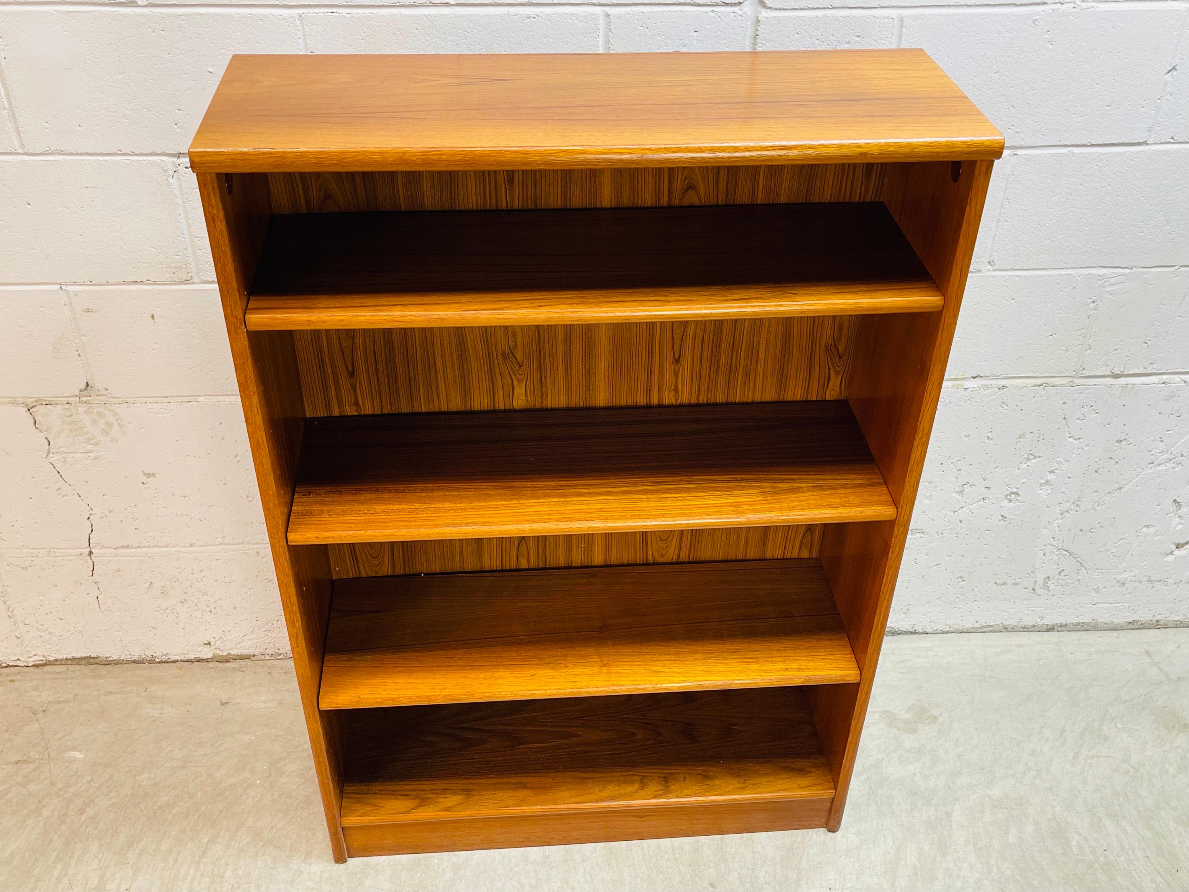 Vintage 1970s teak wood Danish bookcase. The bookcase has adjustable shelves. It has been restored and is strong and sturdy. There is some discoloration to the wood on one side. Marked.