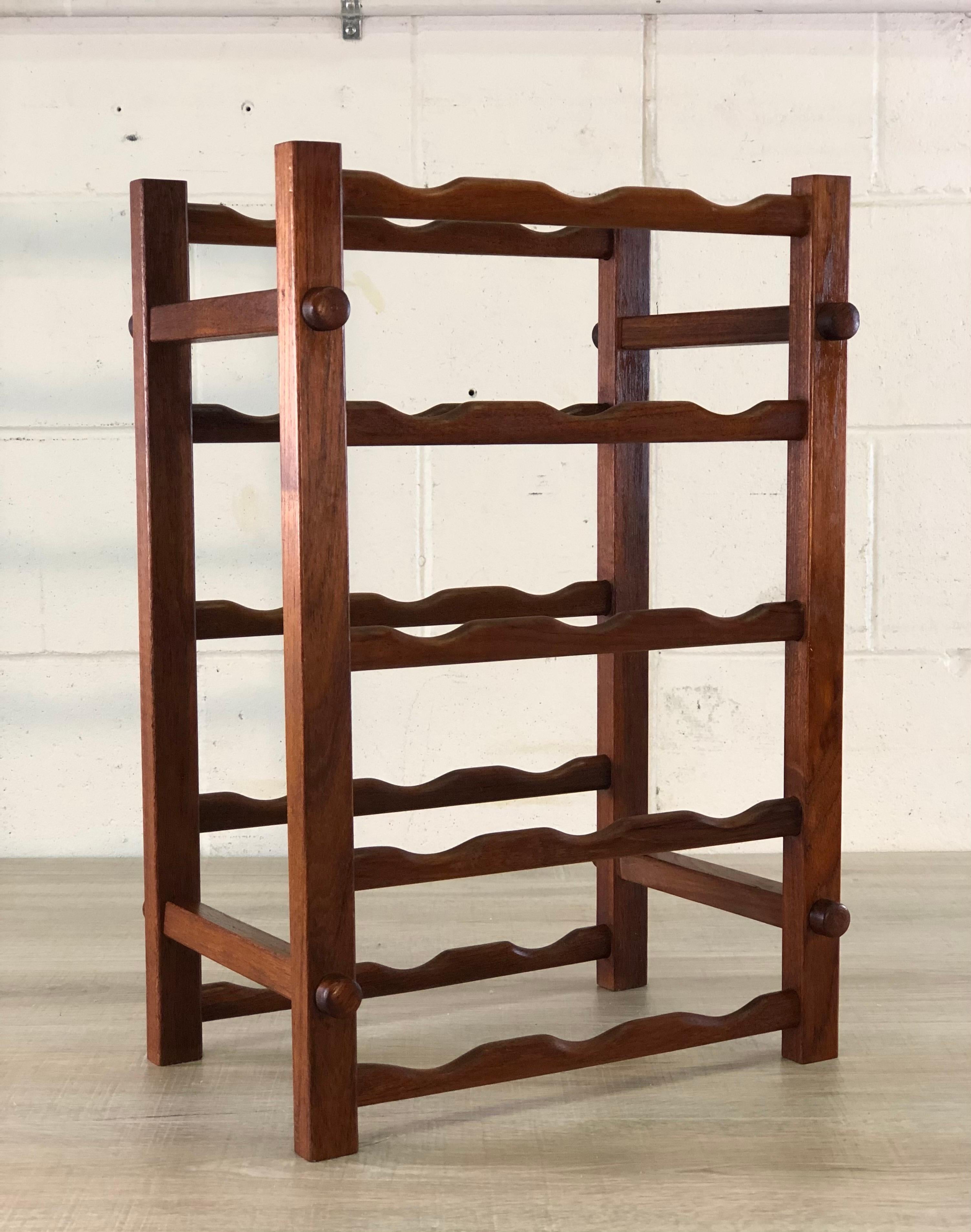 Vintage 1970s teak wood wine rack that holds 15 bottles. Marked.