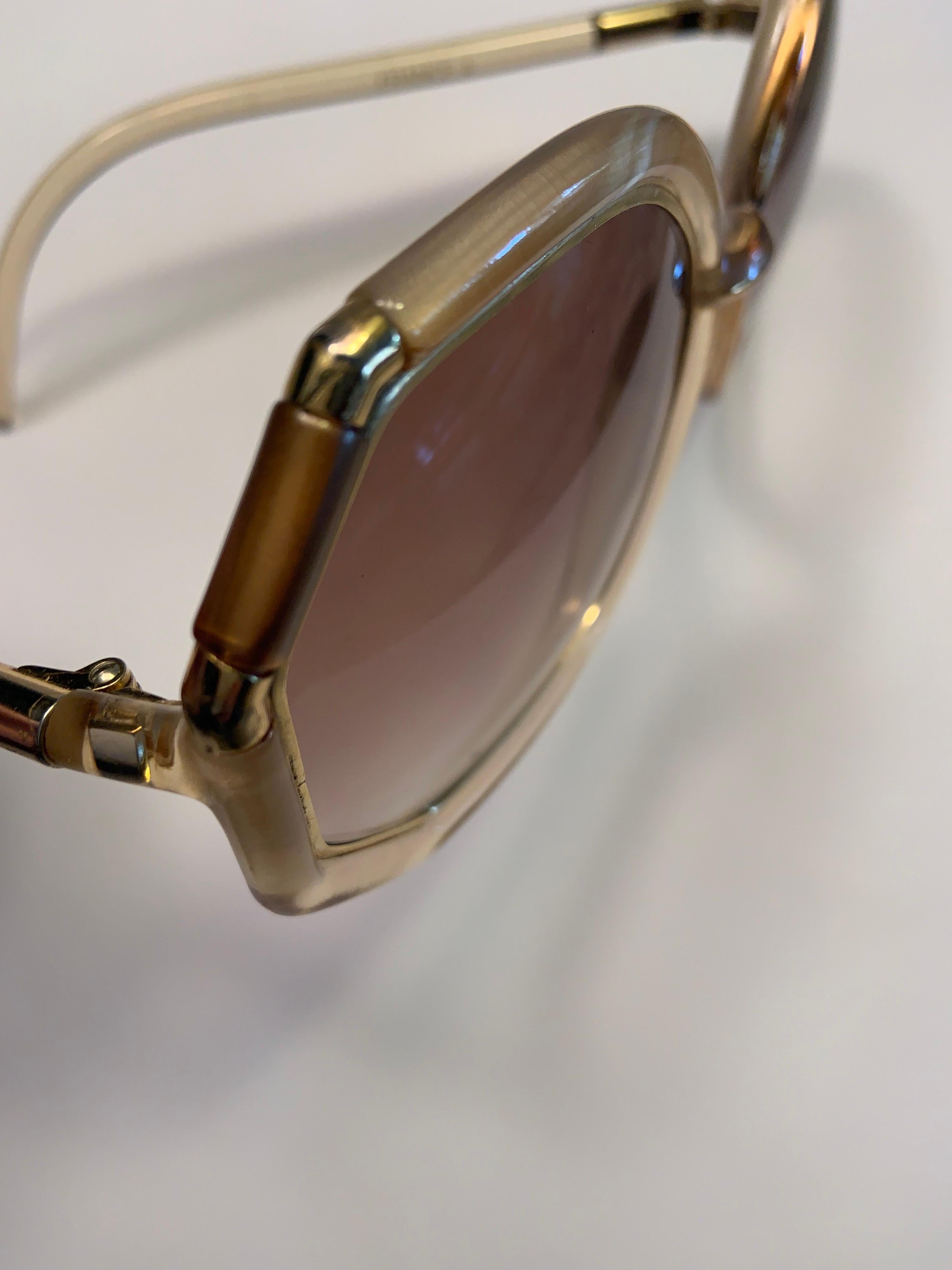 Oversized sunglasses from the 1970's never seem to go out of style.  These glasses are designed by French designer Ted Lapidus and they are Made in France.  The frames are three different colors, Mother of Pearl, gold toned metal, and smoky