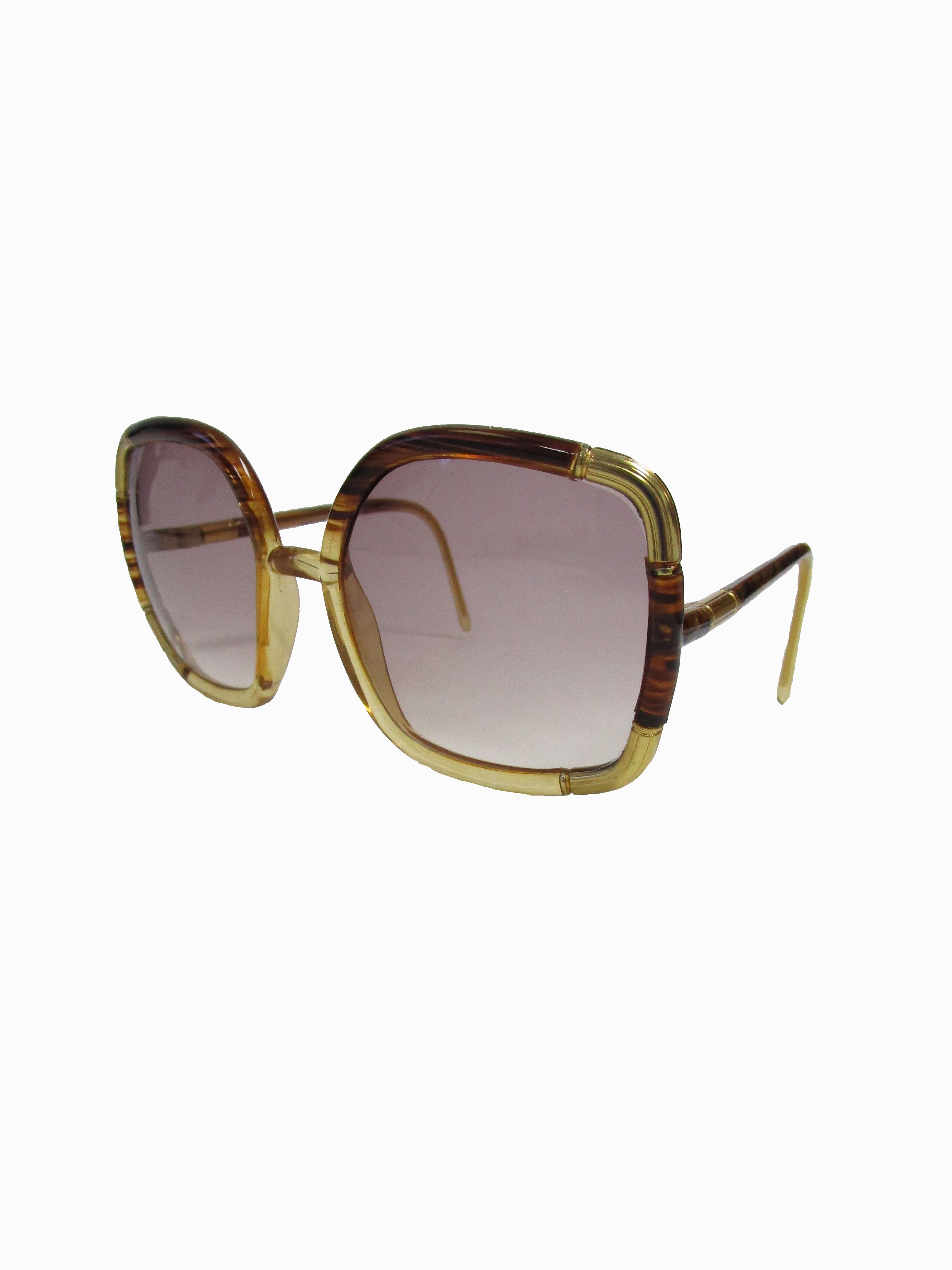 
Classic Ted Lapidus sunglasses in a tortoise acrylic with gold accents and dusky lenses.

Lens Width-57mm
Bridge Width- 15mm
Temple (arm) Length - 149mm