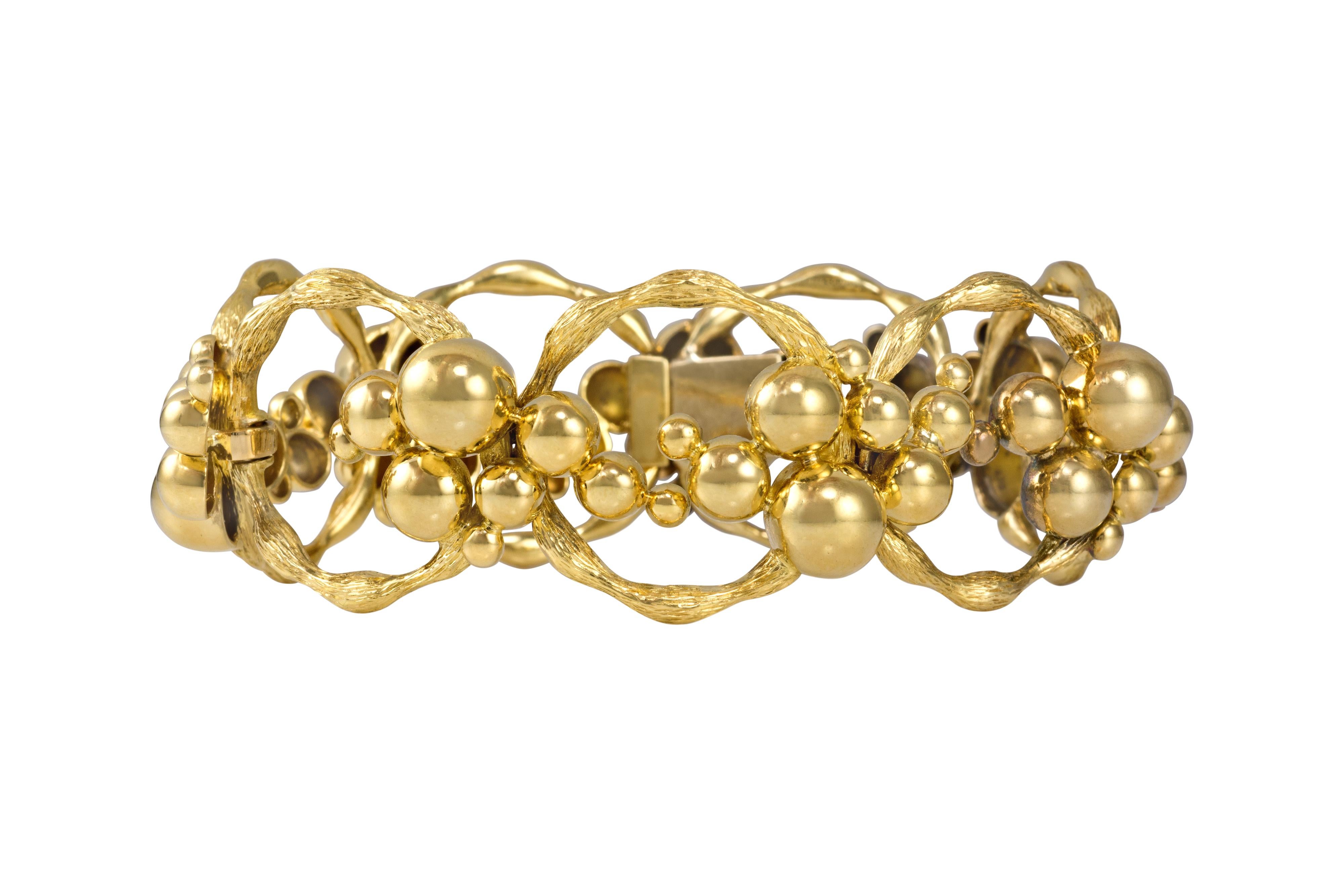 A textured and beaded, 18 karat gold, circular link bracelet, 1970s. 

The bracelet is 7.5