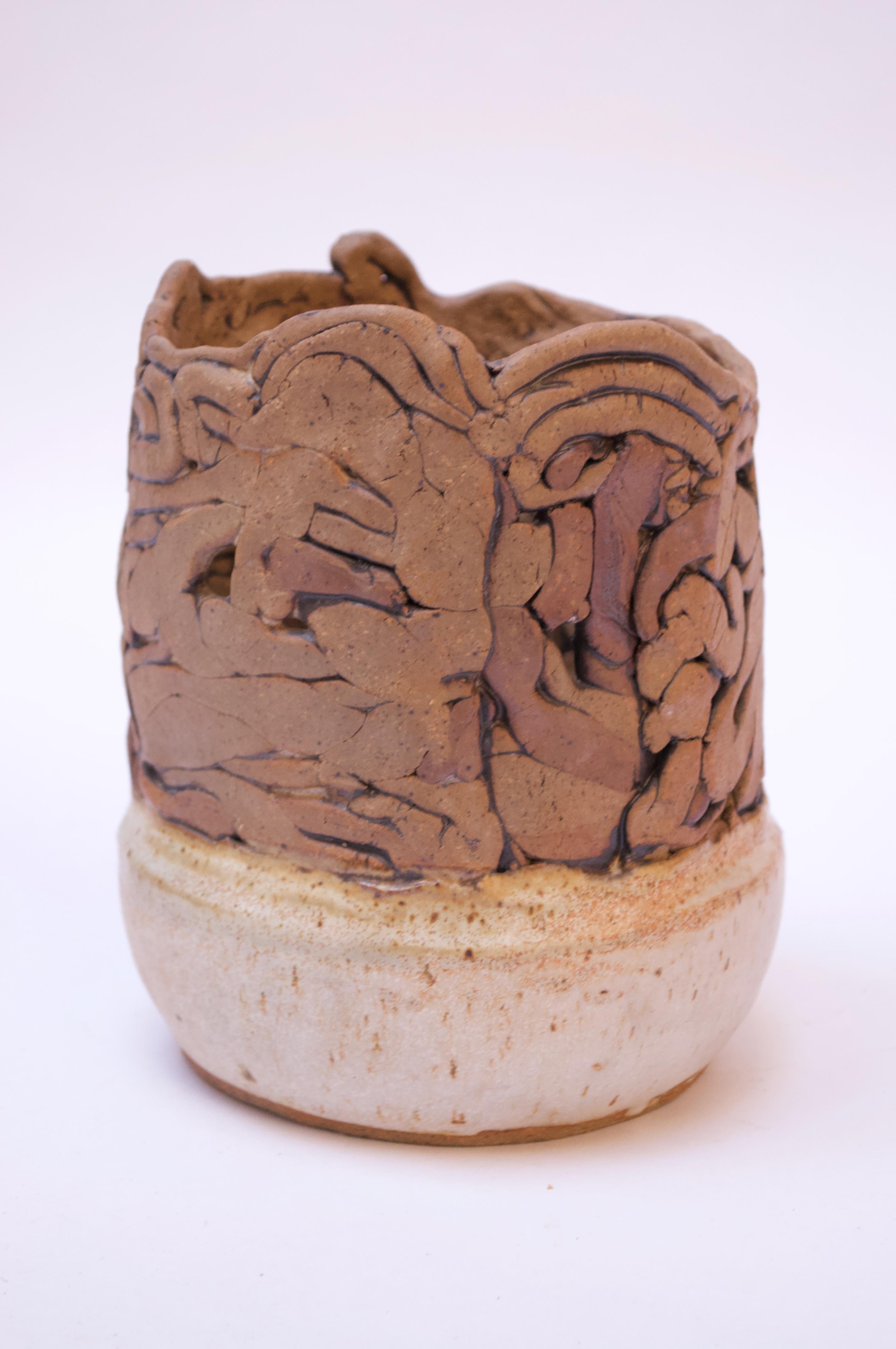 Stoneware vase with densely textured, abstract pattern in brown with a lightly mottled beige base, circa 1970s.
Measures: H 7.25
