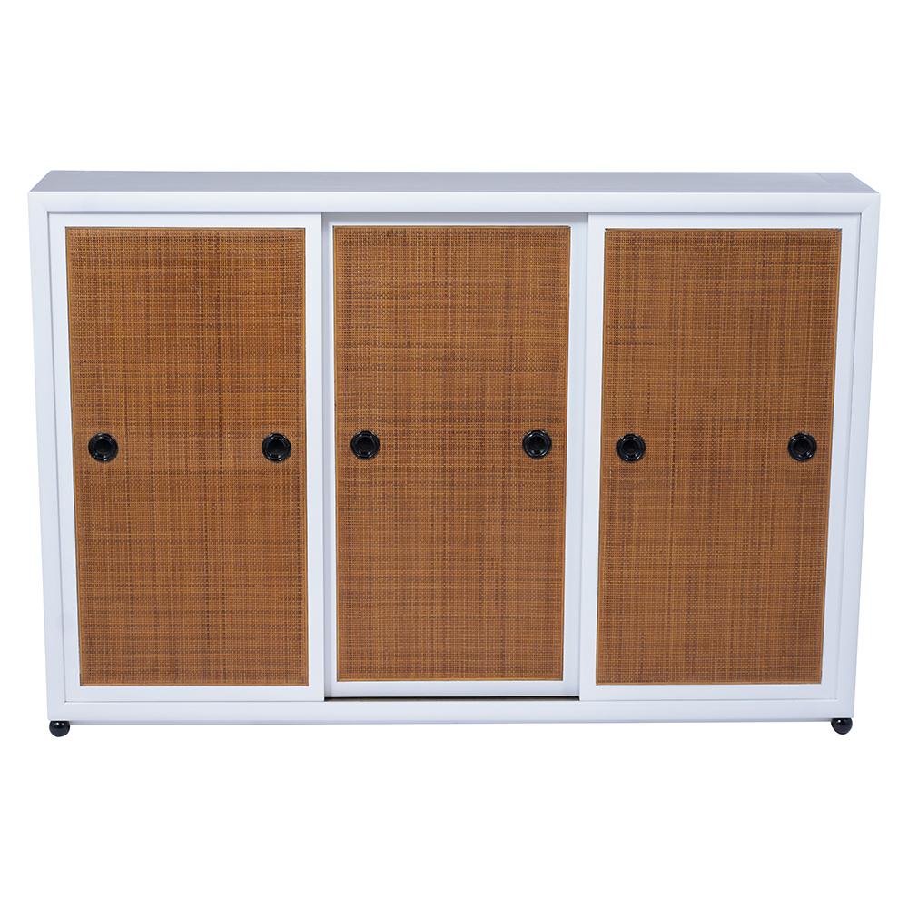 This fabulous 1960s vintage bookcase by Baker is crafted from solid mahogany wood and features a newly stained white and black color combination with a lacquered finish. The cabinet has three framed caned sliding doors with carved handles, and the