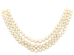 1970s Three Strand Pearl Strand with 5.91 Carat Garnet and Yellow Gold Clasp