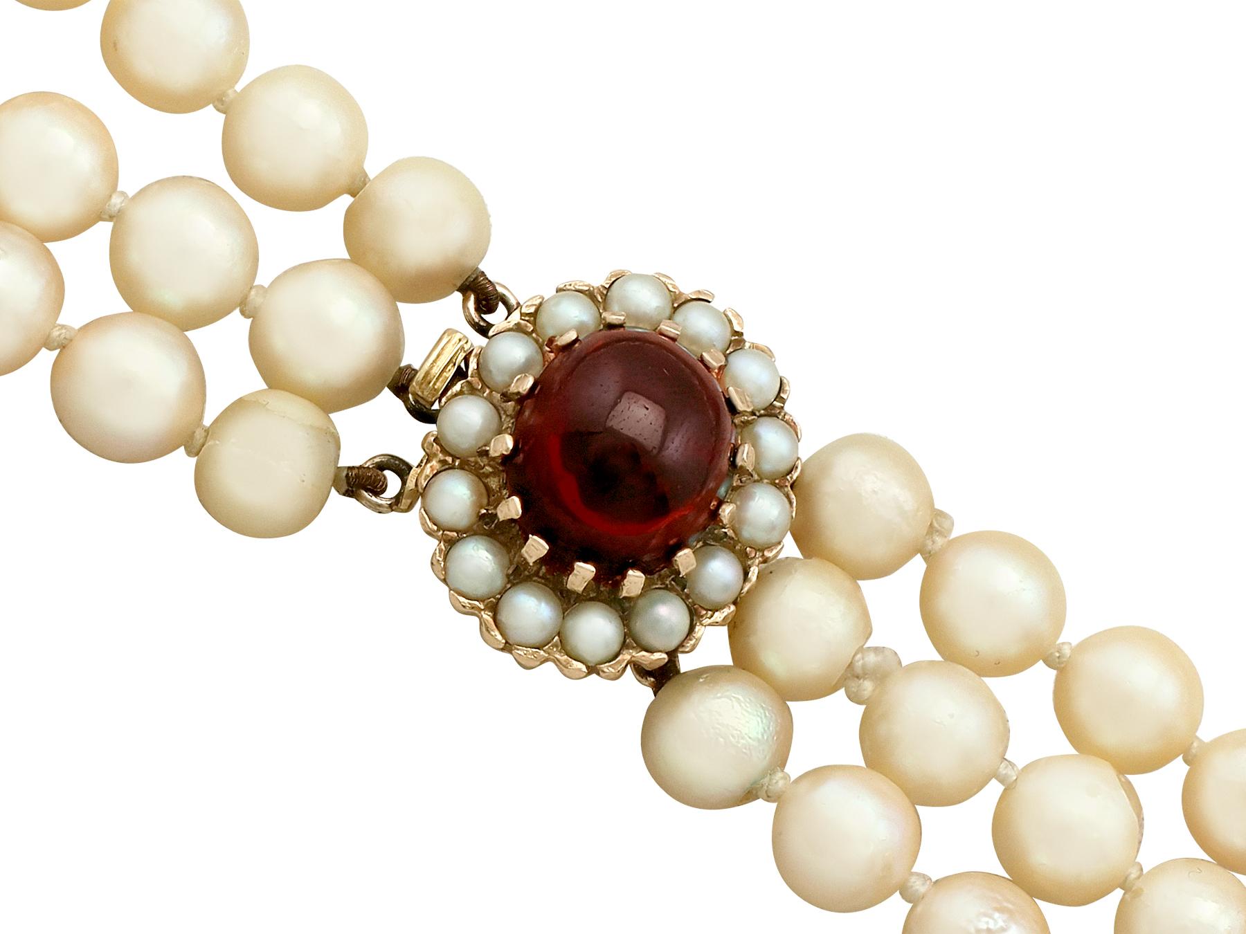 Retro 1970s Three Strand Pearl Strand with 5.91 Carat Garnet and Yellow Gold Clasp