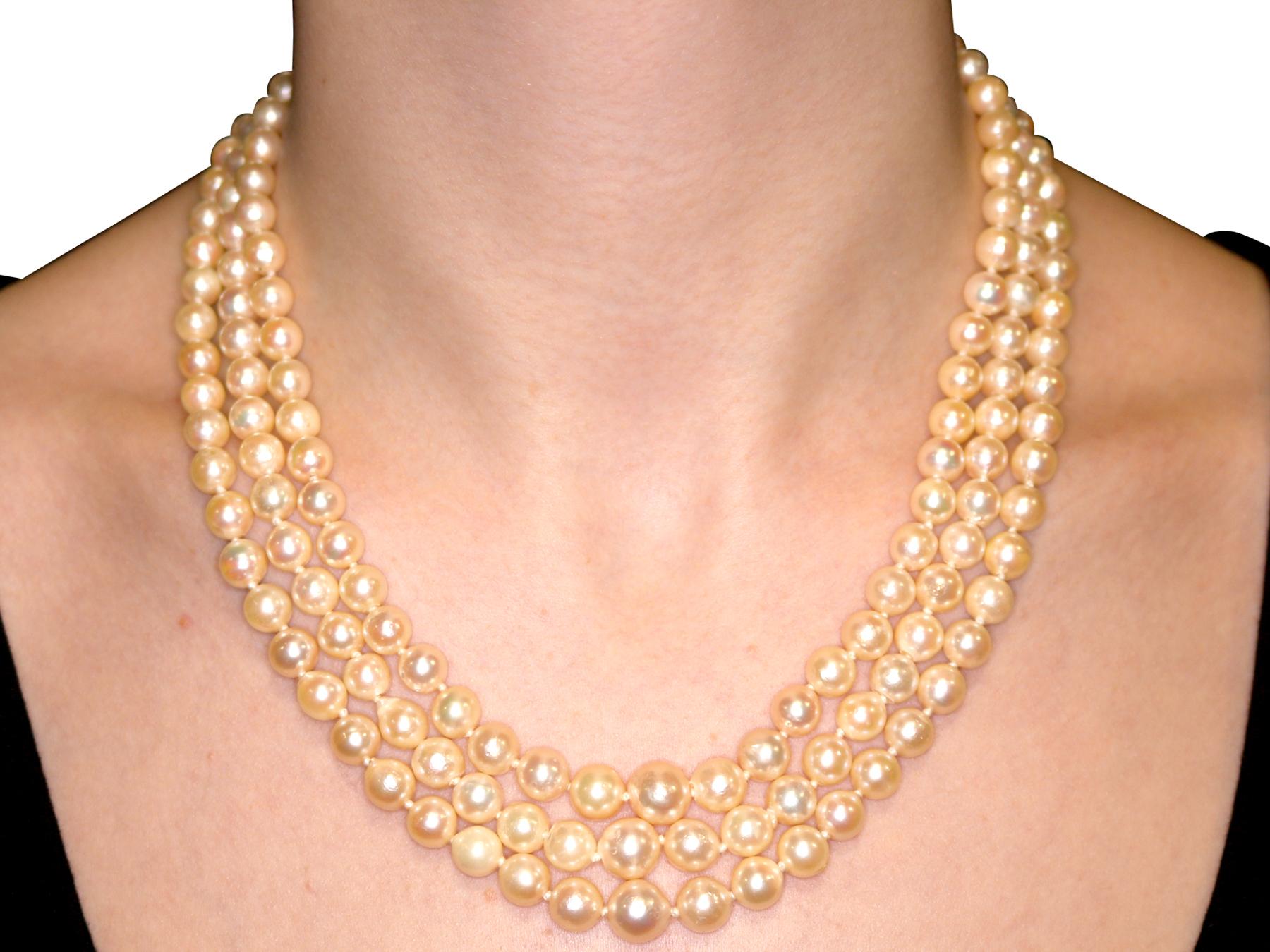 1970s Three Strand Pearl Strand with 5.91 Carat Garnet and Yellow Gold Clasp 1