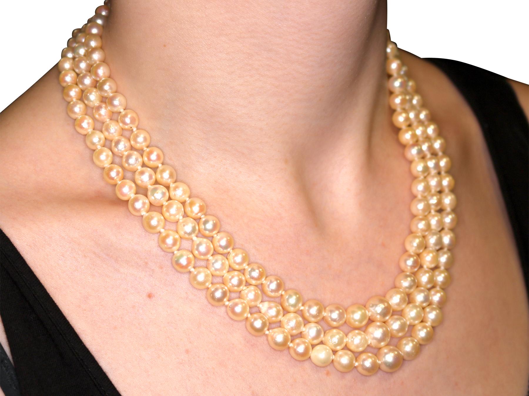 1970s Three Strand Pearl Strand with 5.91 Carat Garnet and Yellow Gold Clasp 2