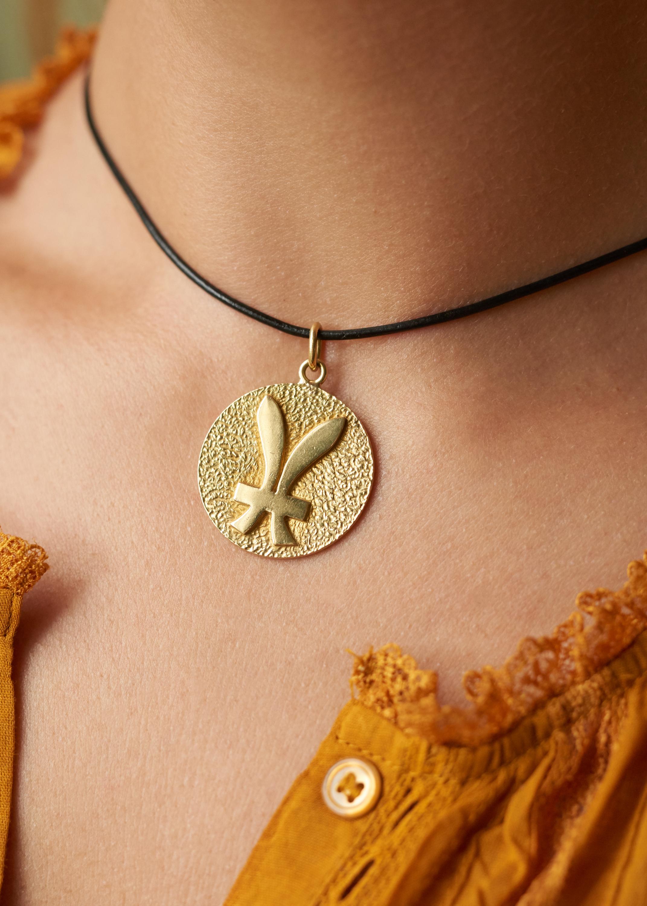 An 18 karat gold Pisces zodiac pendant, by Tiffany & Co., c. 1970. This pendant is sold separately of the cord. A perfect Pisces from the Age of Aquarius.