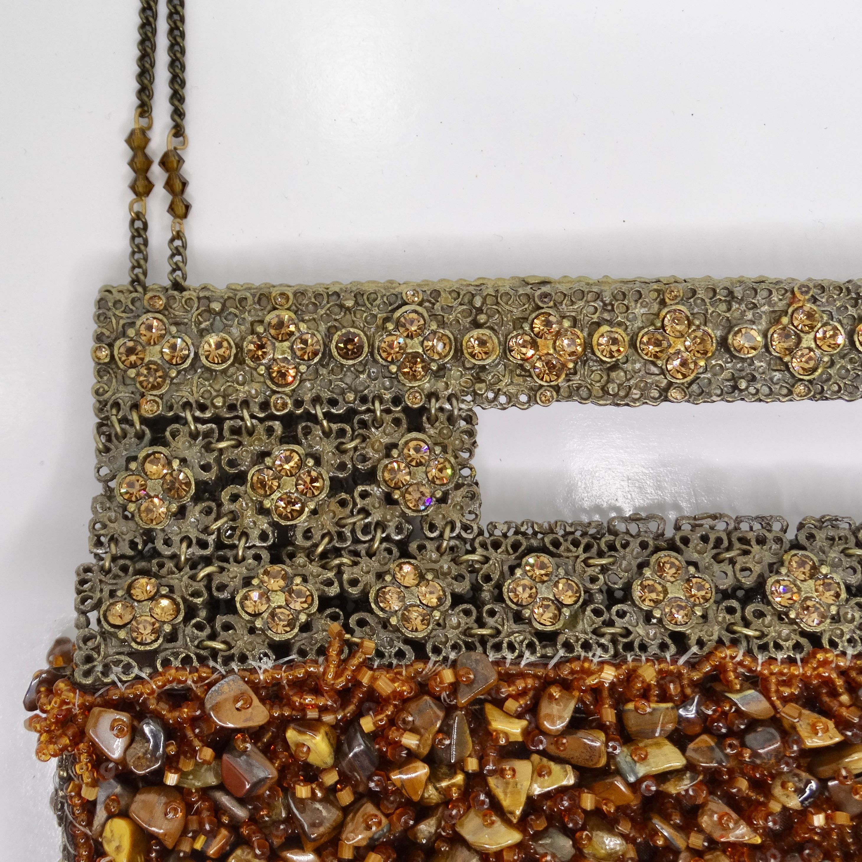 Introducing the stunning 1970s Tiger Eye Stone Swarovski Crystal Embellished Handbag, a true artisanal masterpiece that exudes luxury and glamour. Crafted from bronze-tone metal, this handbag is adorned with a plethora of intricate tiger eye stone