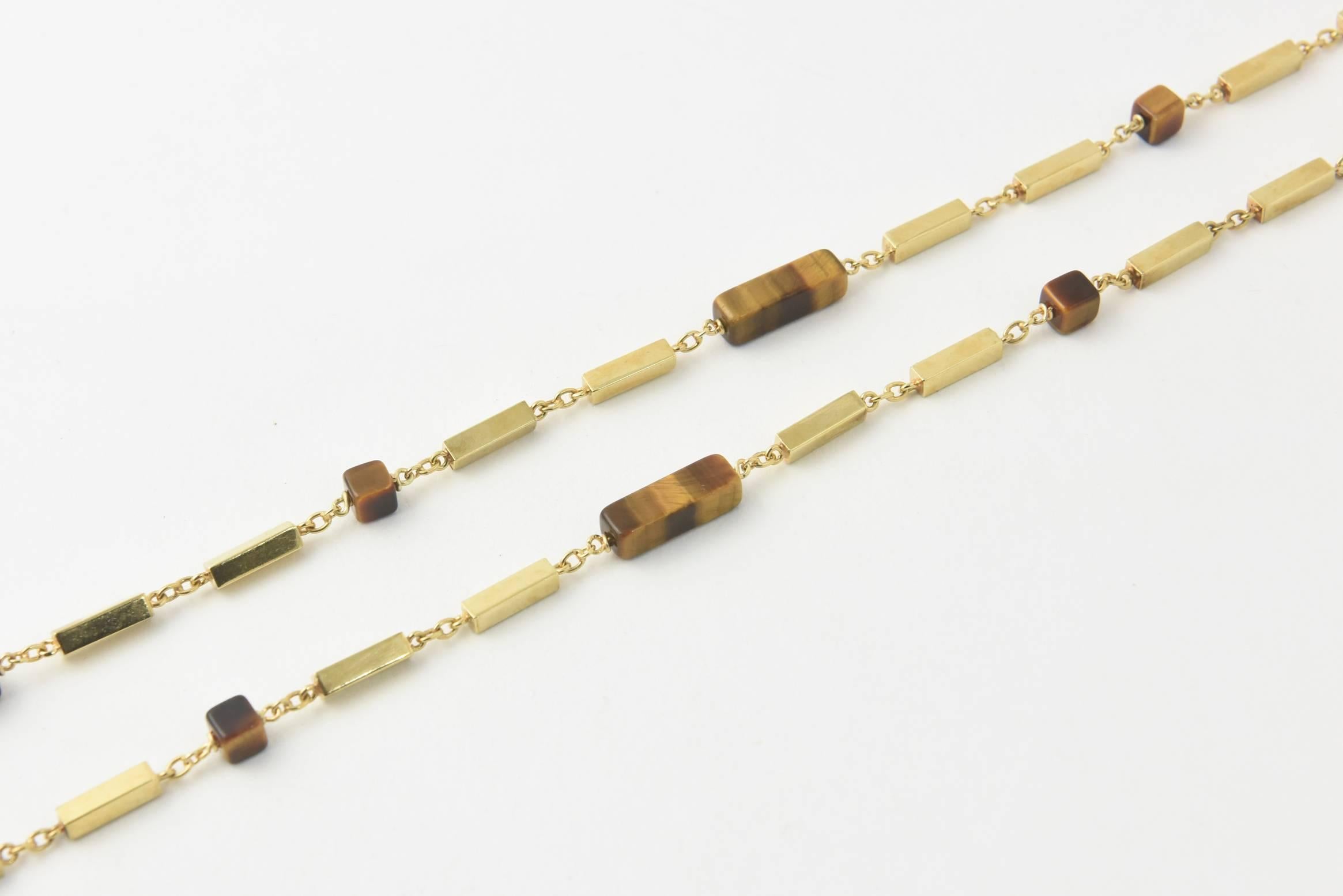 Tiger's eye and 14k yellow gold bar necklace featuring rectangular and square tiger eye beads. Each gold bar, 0.44