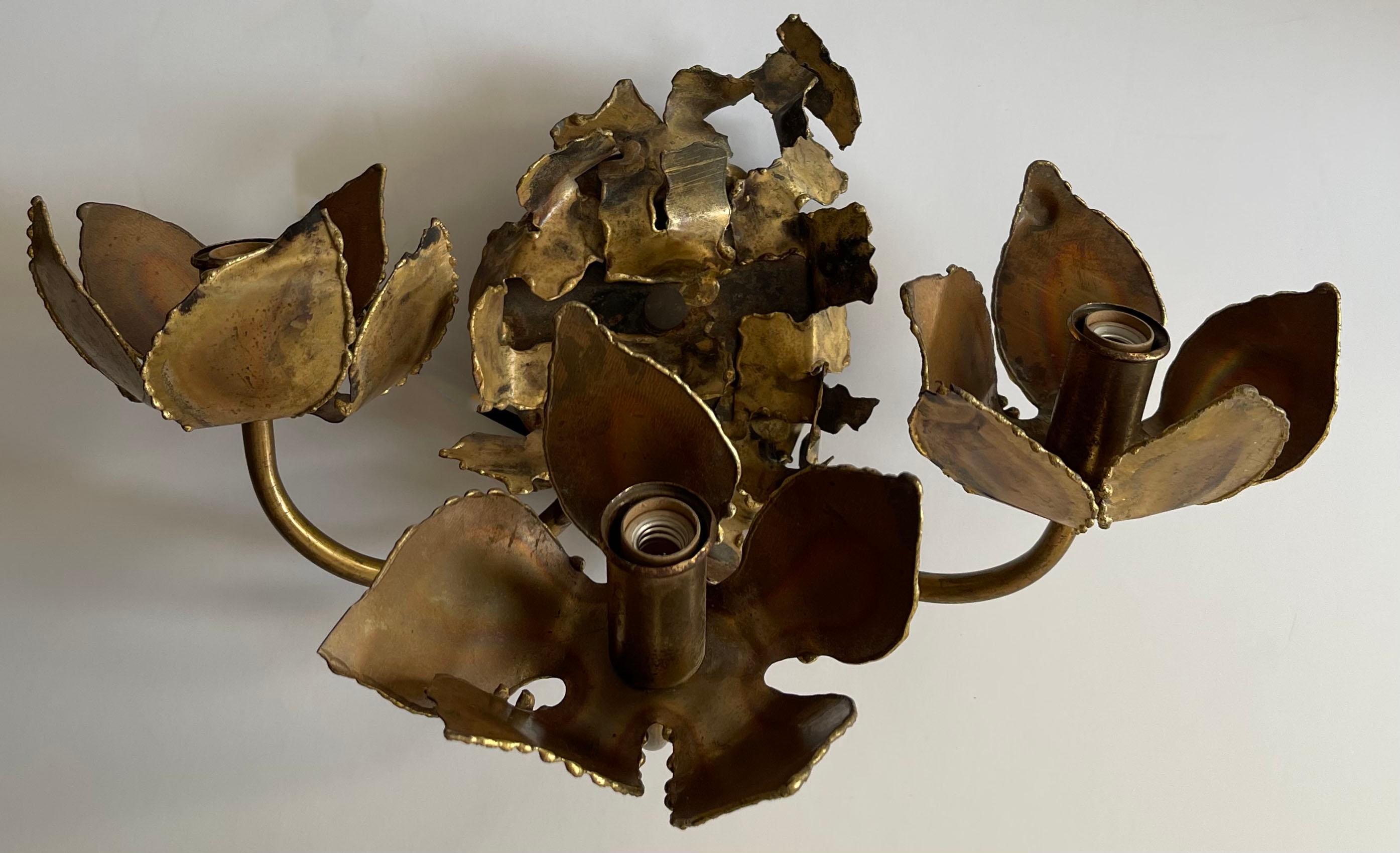 1970s Tom Greene for Feldman Brutalist three light sconce. Burnished metal finish. Newly rewired. Retains Feldman sticker on the back side. Takes three chandelier bulbs (not included).