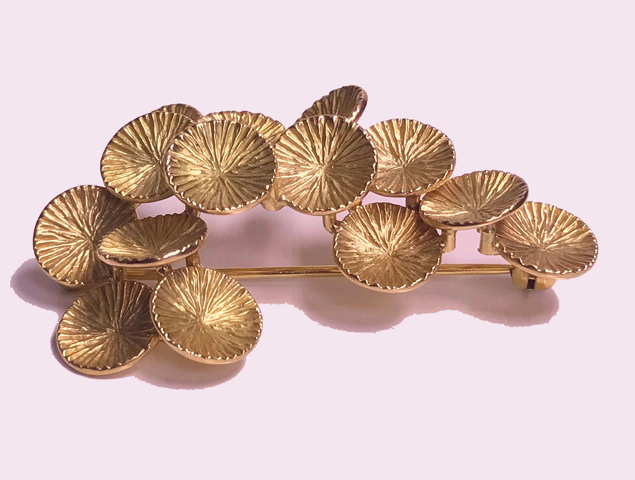 1970's Toni Cavelti Abstract 18K Brooch. The handmade Brooch of textured motif flower petals on branch. Signed to reverse. Measures: 2.5 x 1.0 inches. Item Weight: 9.80 grams.