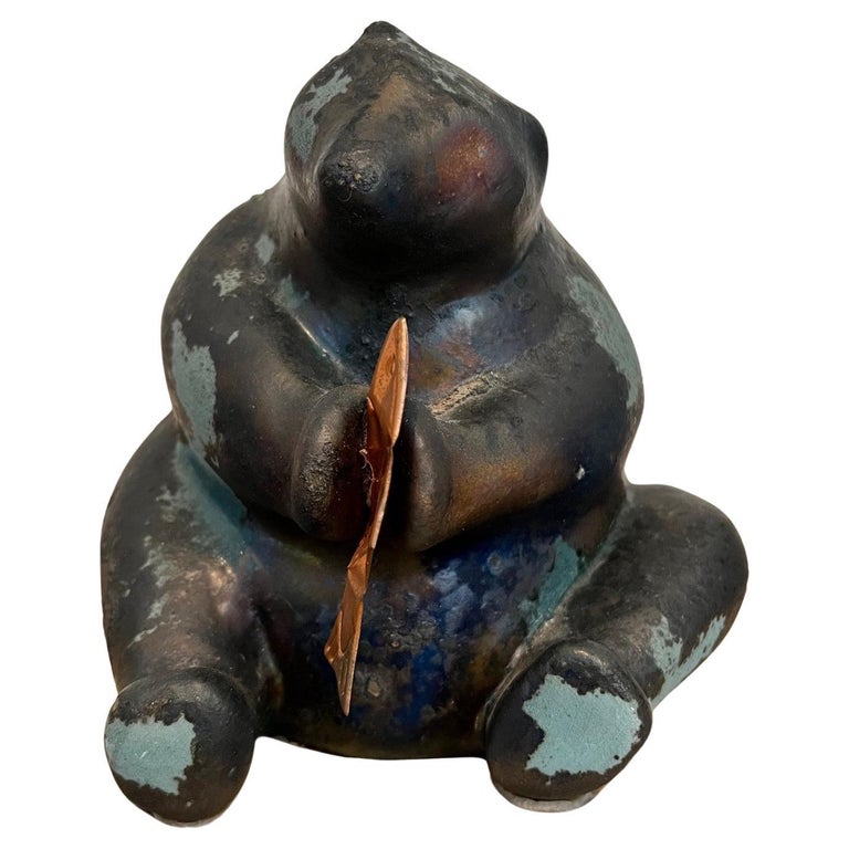 Vintage raku pottery sculpture of a bear sitting on his haunches and holding a copper fish by raku pottery master Tony Evans (1942-2009)Cali. Evan's distinctive style of raku pottery produced interesting fired and burnt glazes, both gloss and matte,