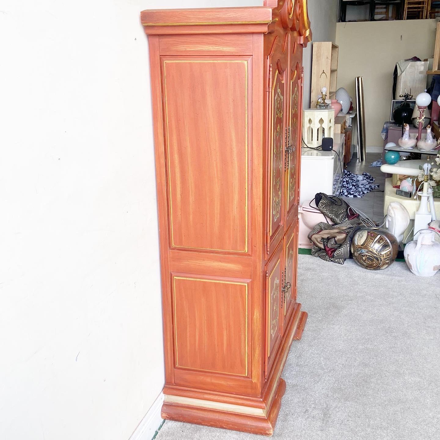 Exceptional rustic armoire by Thomasville marked 1971. Features a painted red distressed over a gold.
   