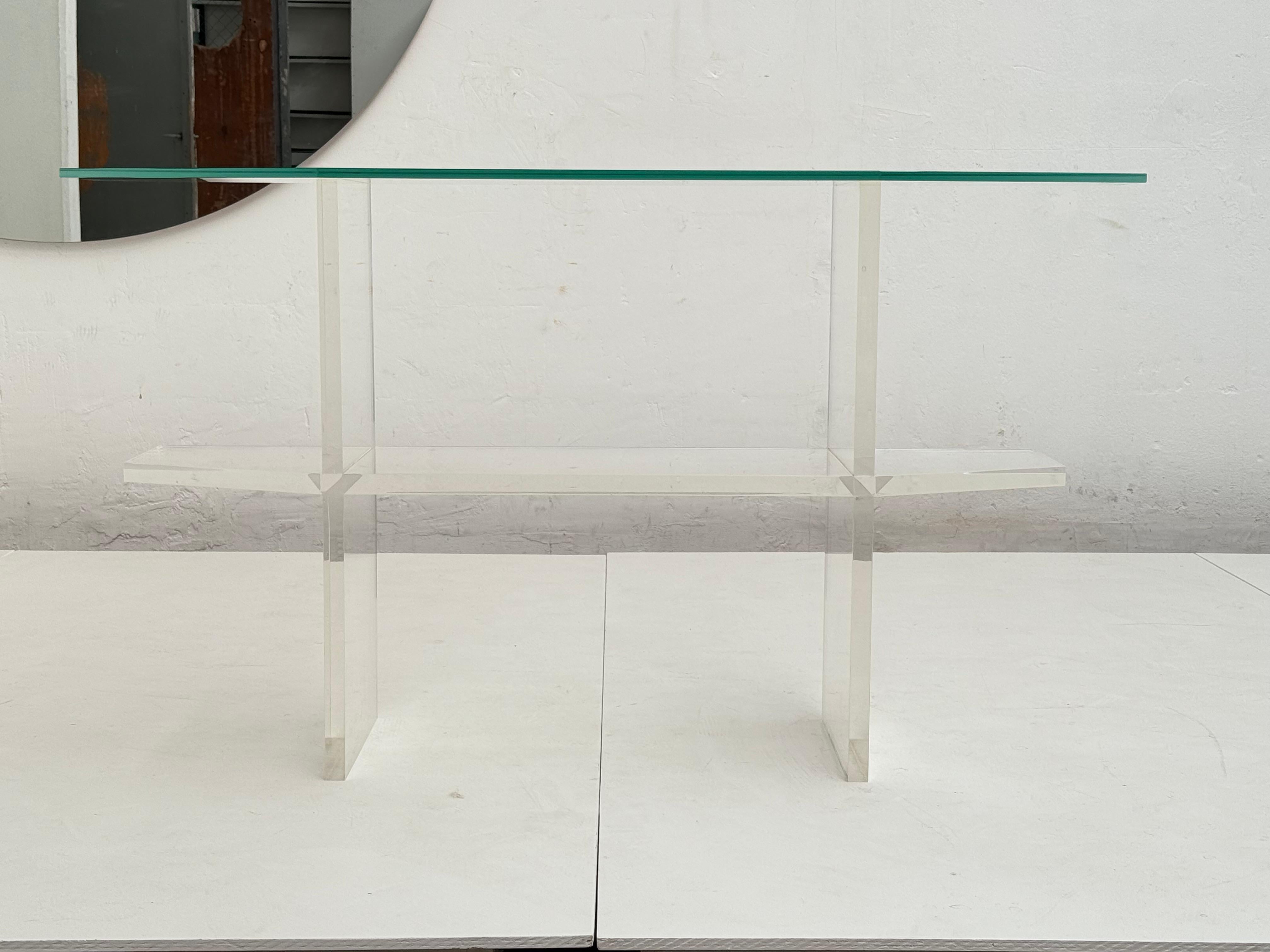 An Elegant and Timeless French 1970's double tier Lucite and glass trapezoid form console table

In the style of Pierre Vandel 

This piece expresses the essence of Modernism with its rare form and lines, its open, spacious, transparent aesthetic
