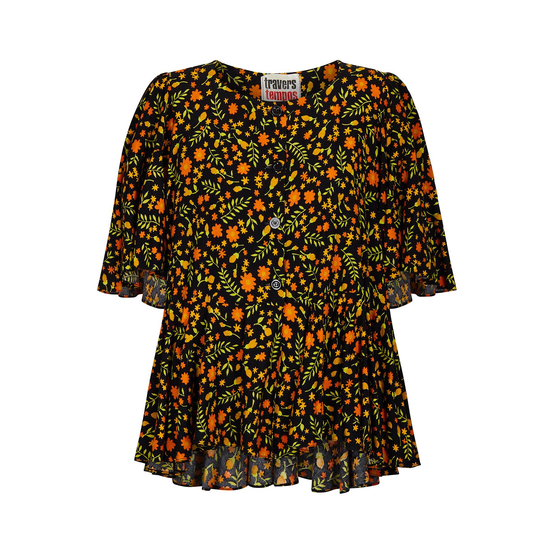 This collectable Travers Tempos top originates from the very late 1960s or early 1970s at the height of the London Fashion scene of the swinging 60s. An oversized style featuring a vibrant, repeat floral print in yellow, orange, green and black and