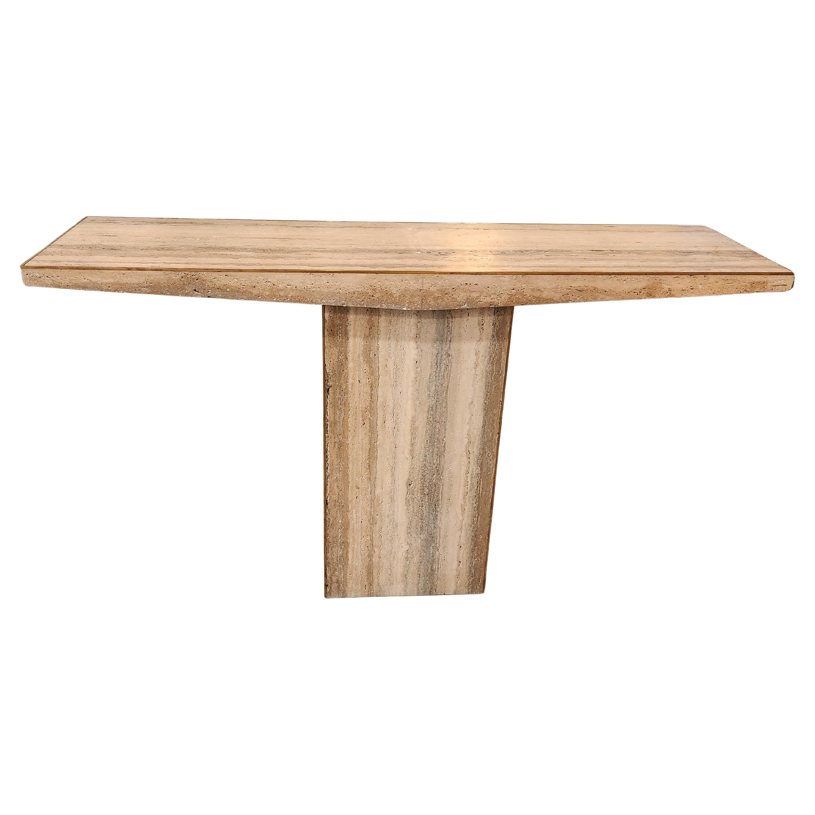 Chic Travertine Console Table. Both sides are finished so it doesn't need to be against a wall. It could easily sit in an entranceway or hallway and make an impactful statement. The stone is particularly beautiful and the detail of the brass edge