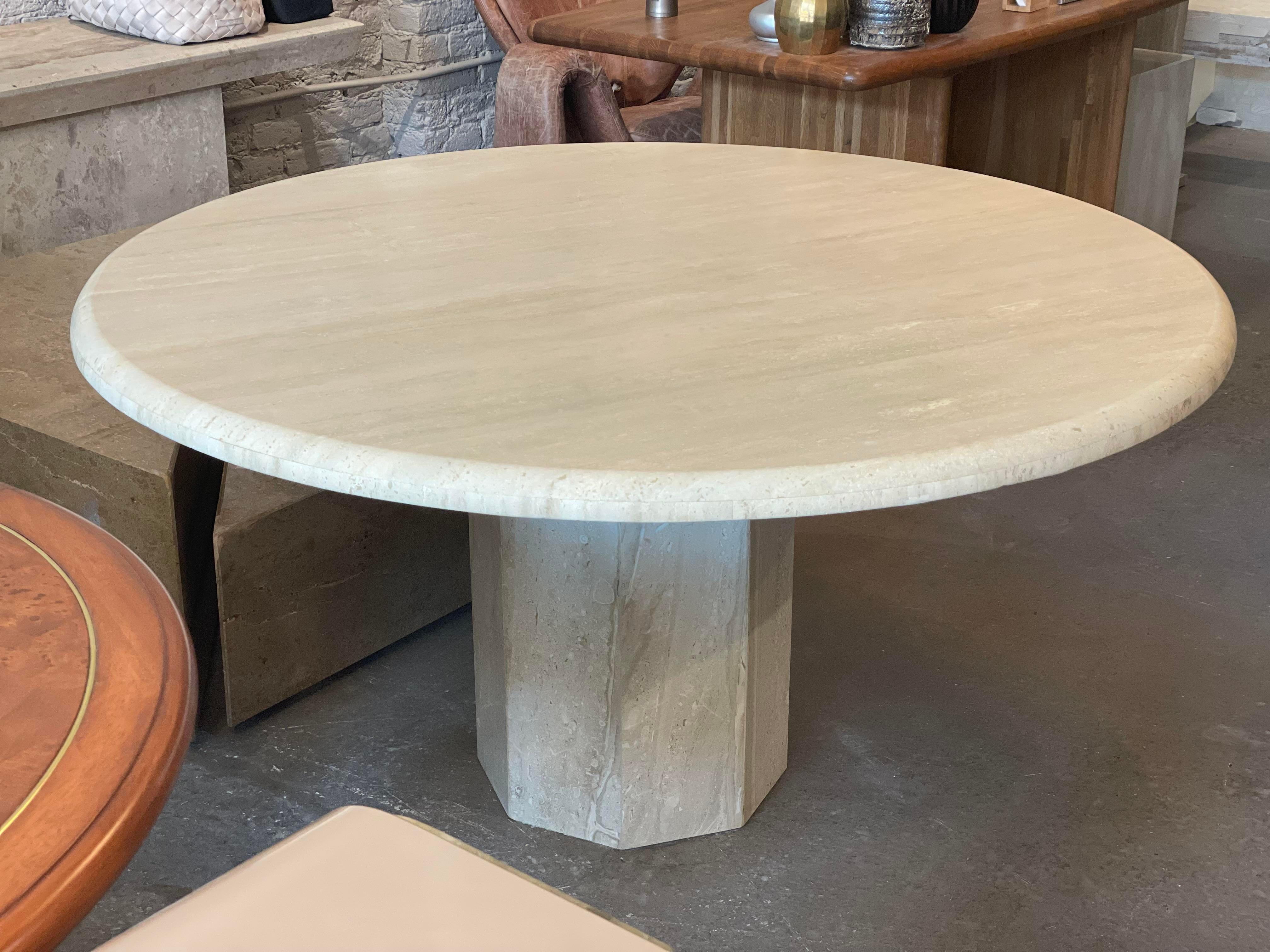 Stunning round dining table from the 70s. Love the bullnose edge and size. 54” easily sits 6.
The table was previously lacquered which was professionally removed. The top and base are now honed, creating a muted natural look.
  