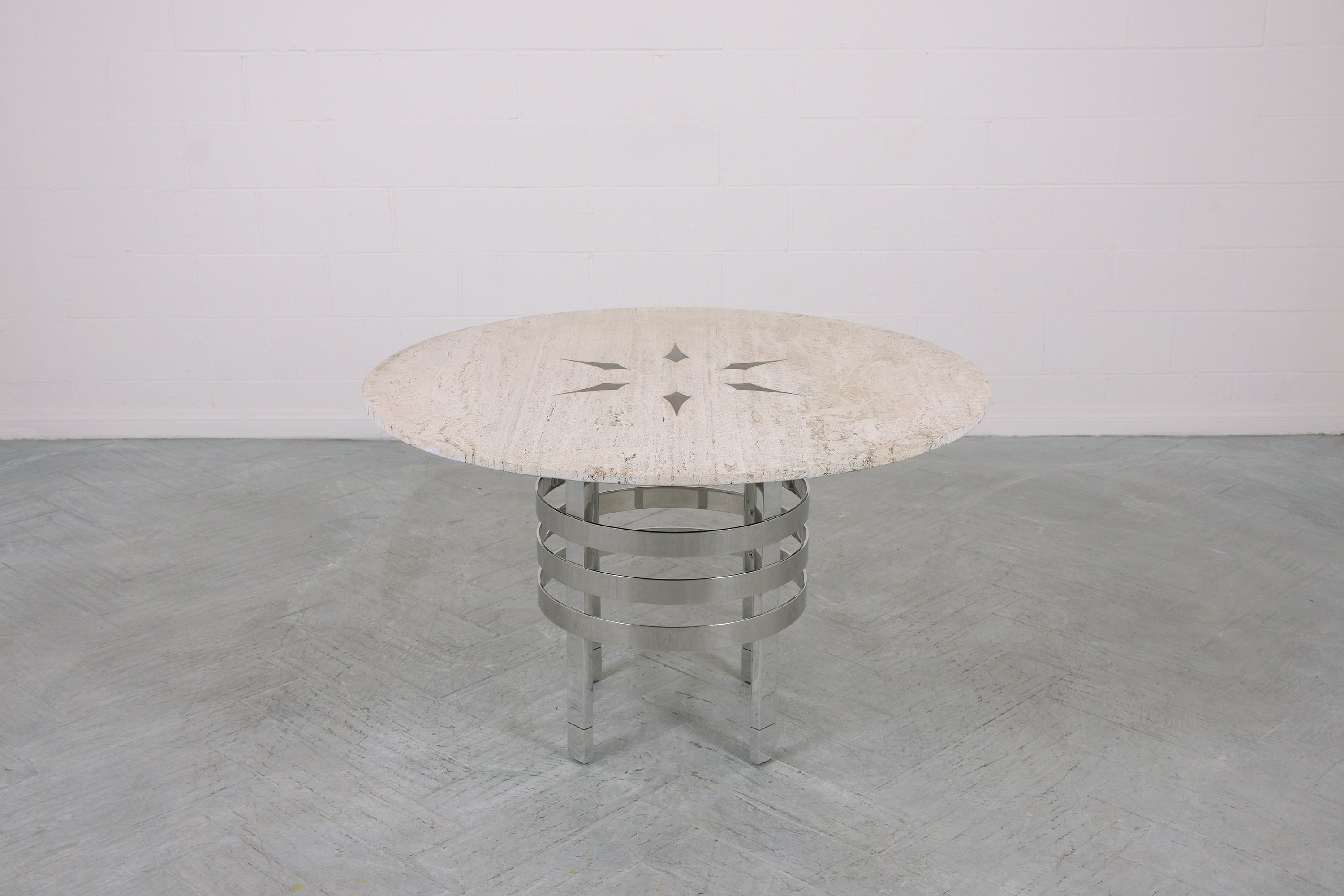 Step into the world of 1970s sophistication with our stunning travertine top dining table, a magnificent piece that embodies the sleek design ethos of the mid-century era. Expertly crafted from steel and travertine marble, this table has been newly