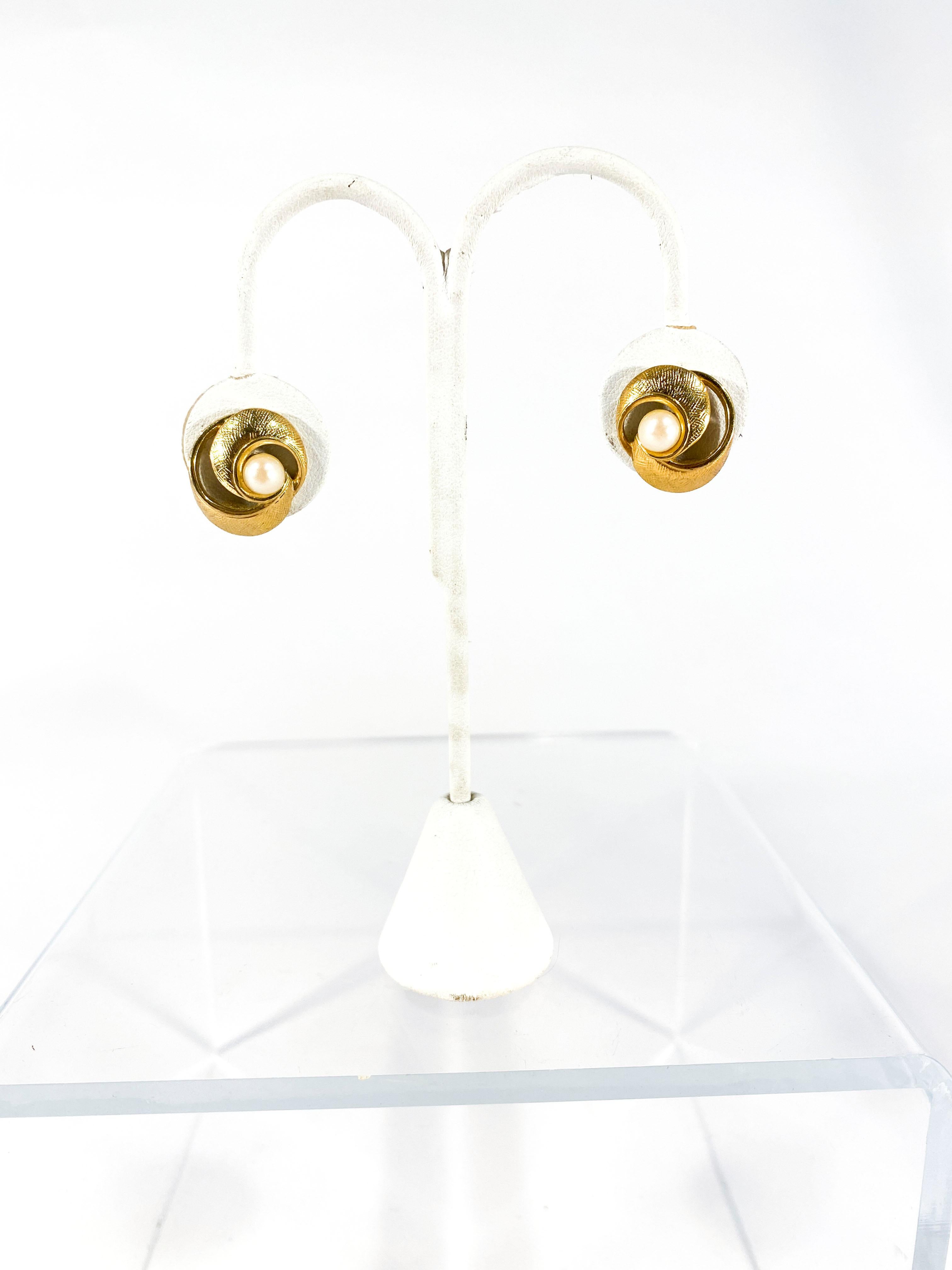 1970s Trifari gold-tone brass clip on earrings centered with a faux pearl.