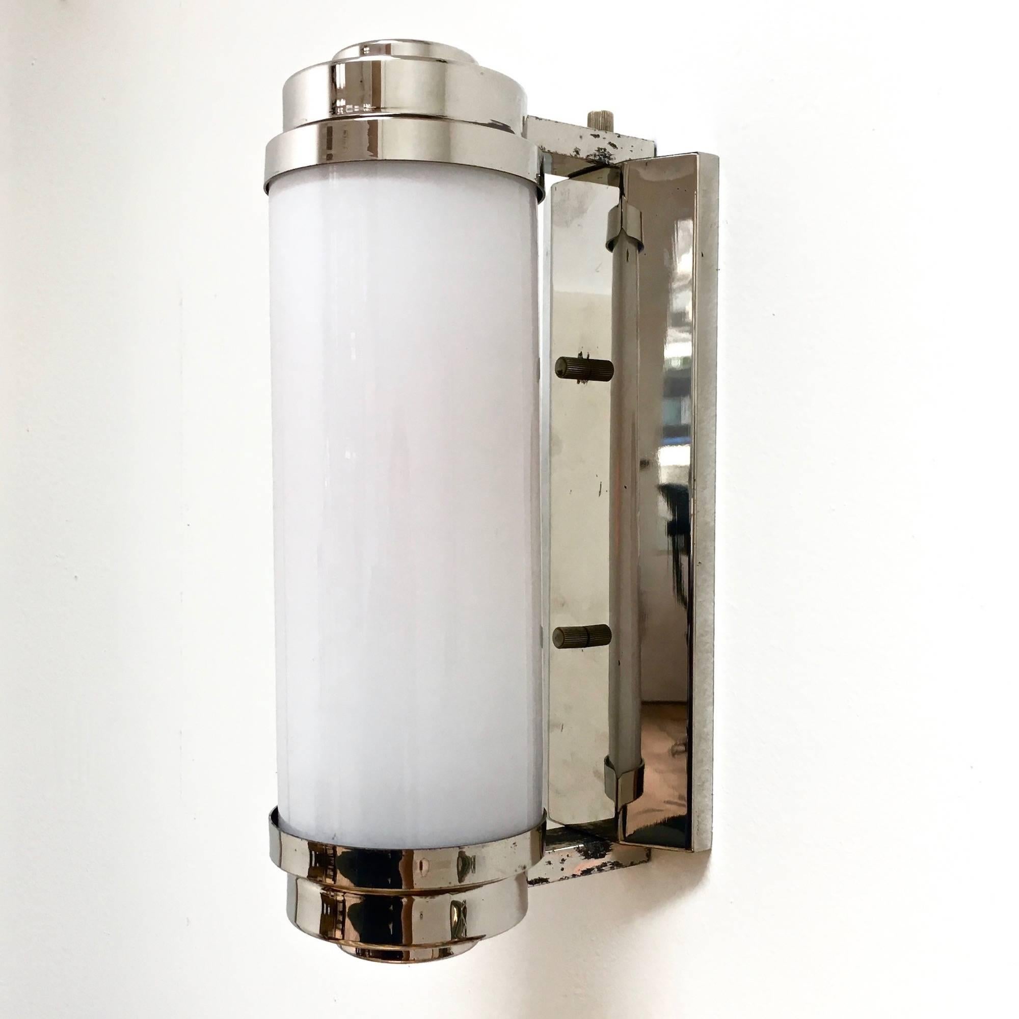 Tubular sconces in opaline glass and chromed brass.