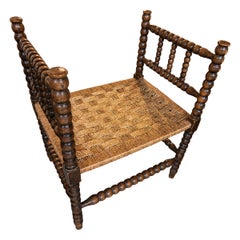 1970s Turned-wood Armchair with a Seat Woven from Natural Fibers.