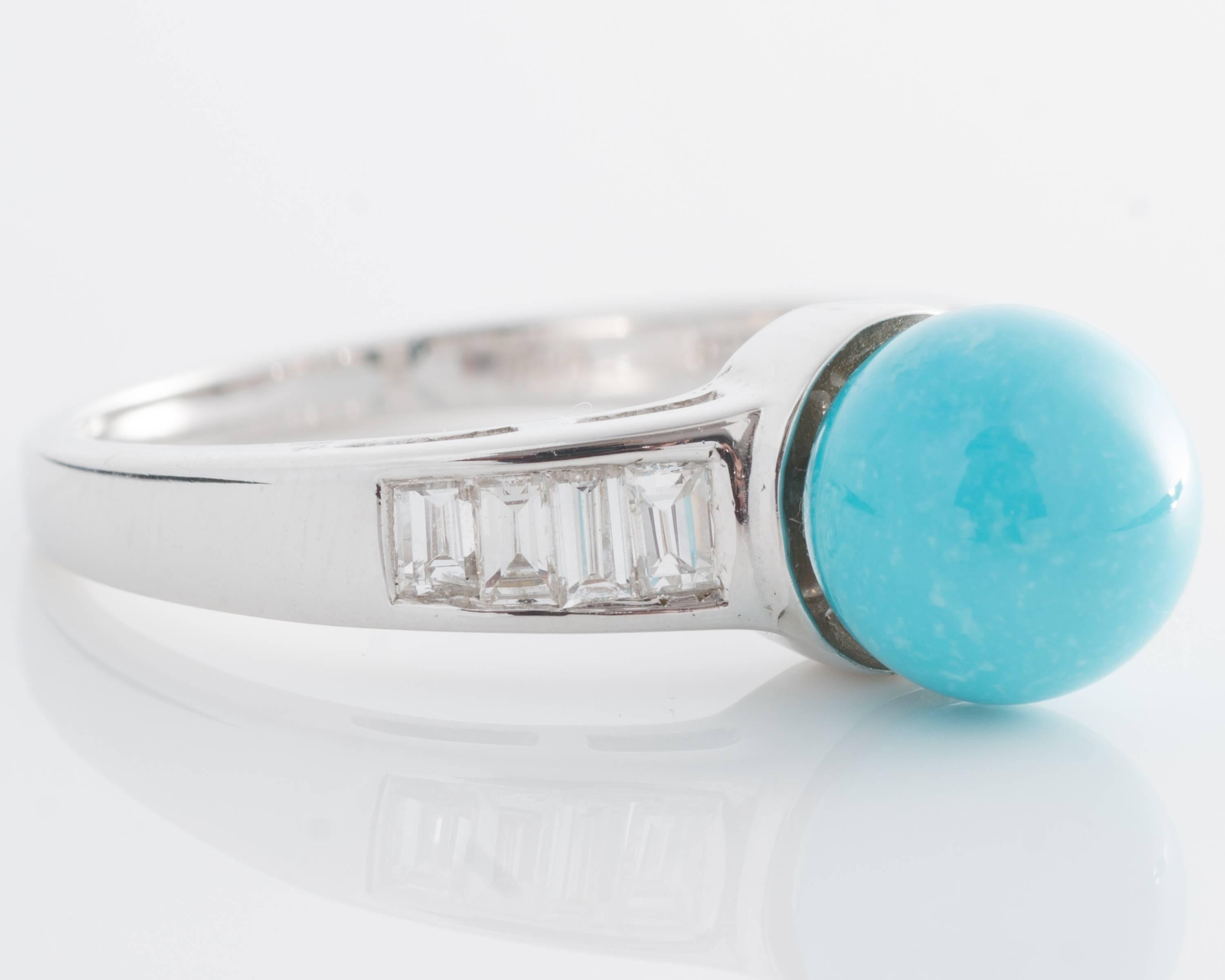 Vintage 1970s Ring - 18K White Gold, Turquoise, Diamonds

Features an 8 millimeter Turquoise cabochon and 8 Diamond Baguettes.
The gorgeous blue Turquoise is center set. It is flanked by 4 Diamond baguettes on each side. The ring shank is crafted