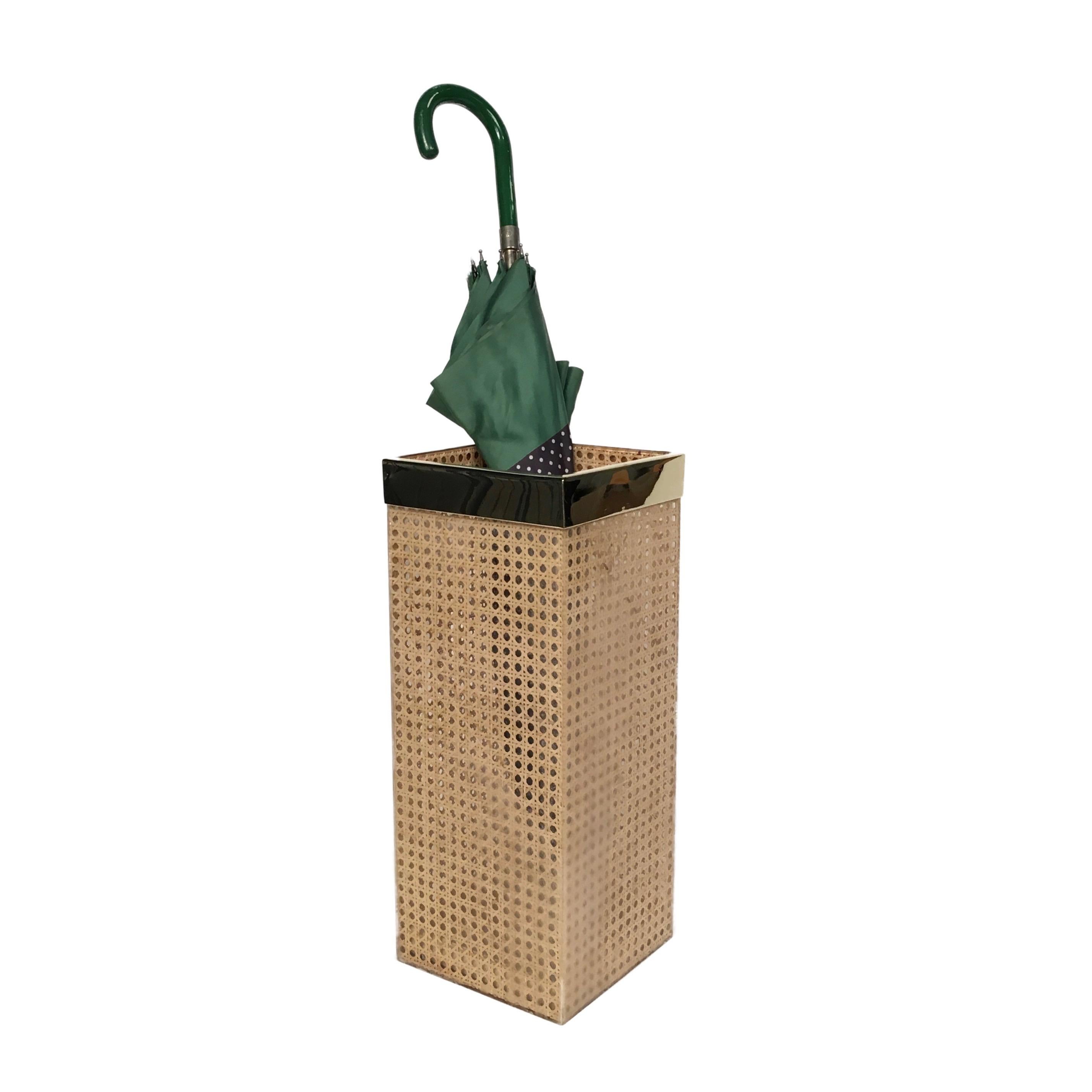 Umbrella stand in the midcentury style by Christian Dior Home collection and designed by Gabriella Crespi. Geometric shape with gilt brass gallery and real rattan cane-work embedded in the crystal clear Lucite. Great accessory for any modern