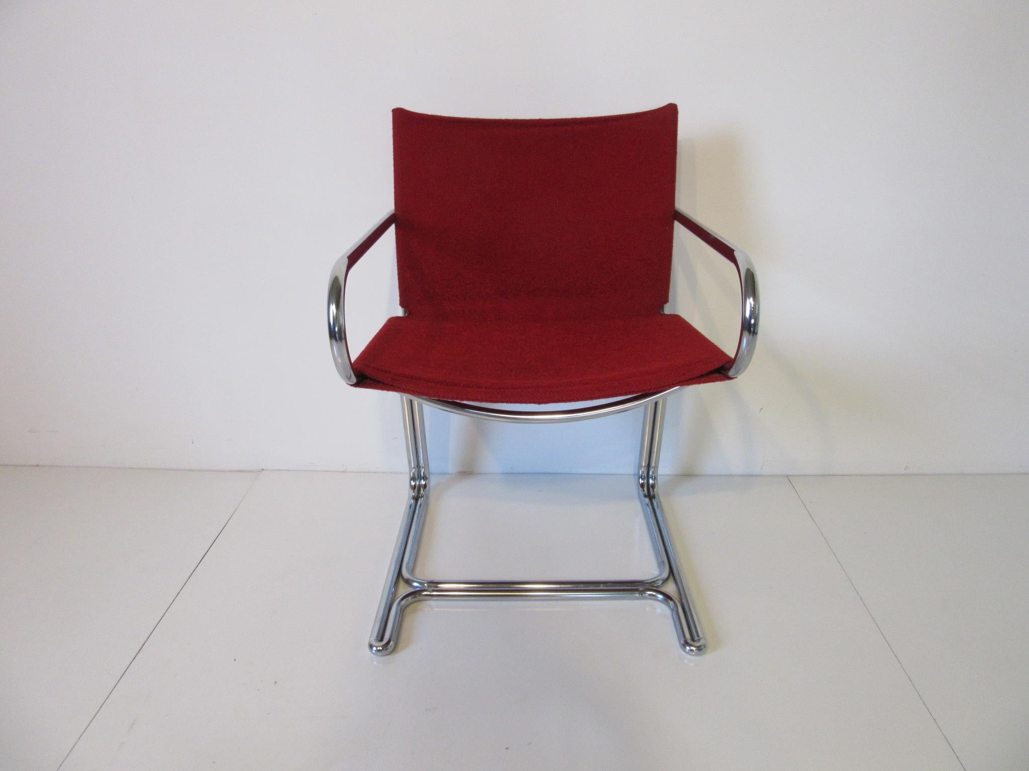 A set of four red upholstered sling style cantilevered arm chairs with bent tubular chrome frames, comfortable and compact from the 1970s. Can be used in the dining room, game room or business environment in the manner of Marcel Breuer.