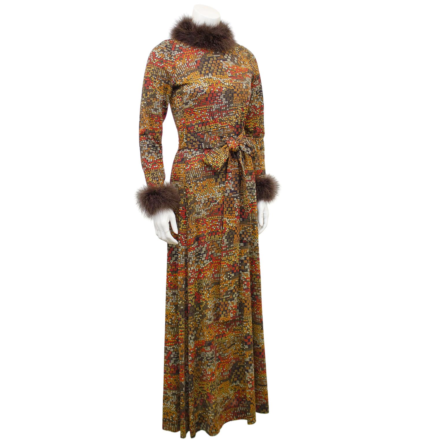 1970s jersey hostess gown from Italian designer Valditevere. Brown with an allover mid century modern print in shades of orange and beige. Long sleeves with brown marabou trim at neck and wrists. Optional waist belt. Invisible zipper up centre back.