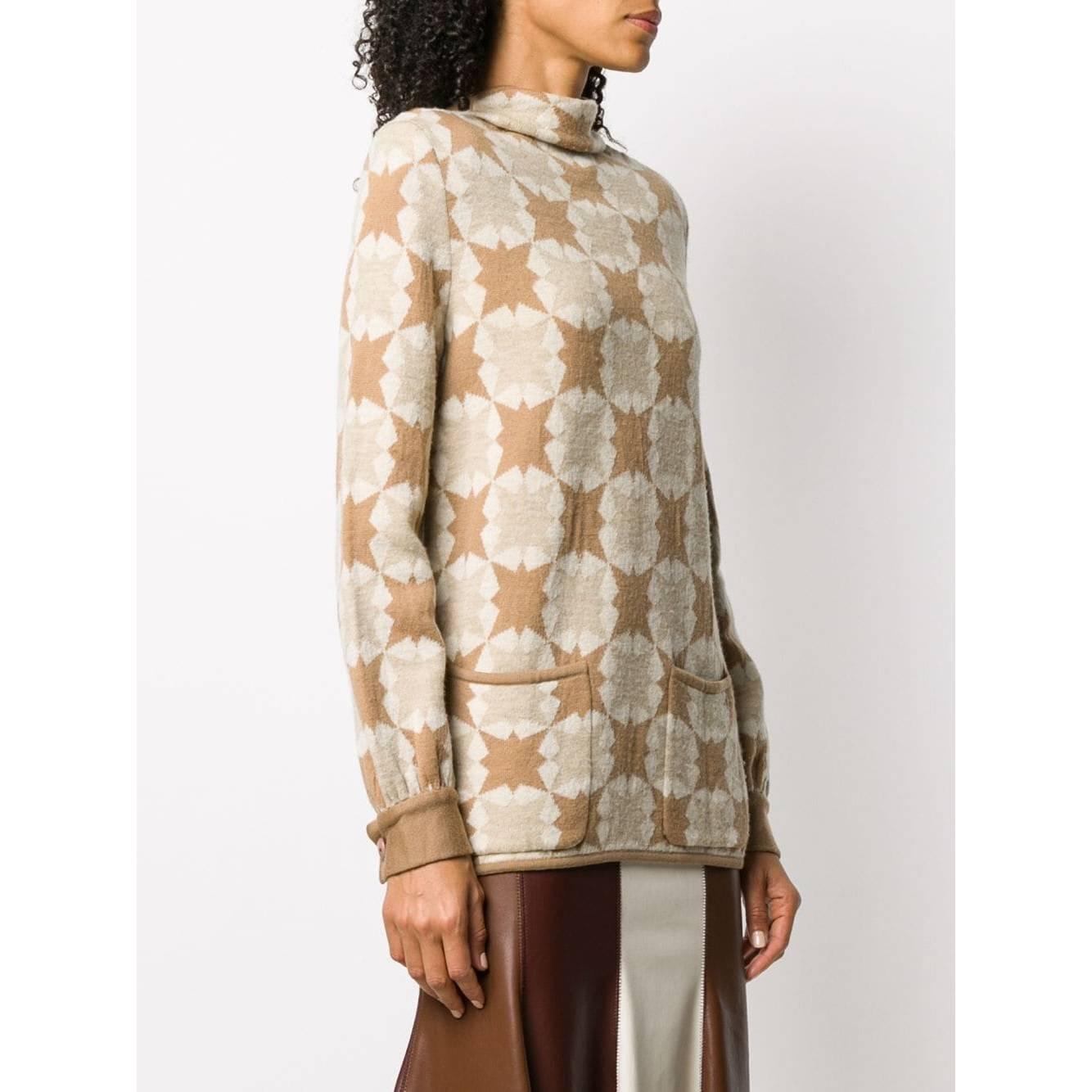 Valentino Boutique beige and brown geometric pattern wool sweater. Slightly stand-up collar, long sleeves, buttoned cuffs, two patch front pockets and straight hem. Slightly padded shoulders.

The item shows signs of wear on the fabric and buttons,