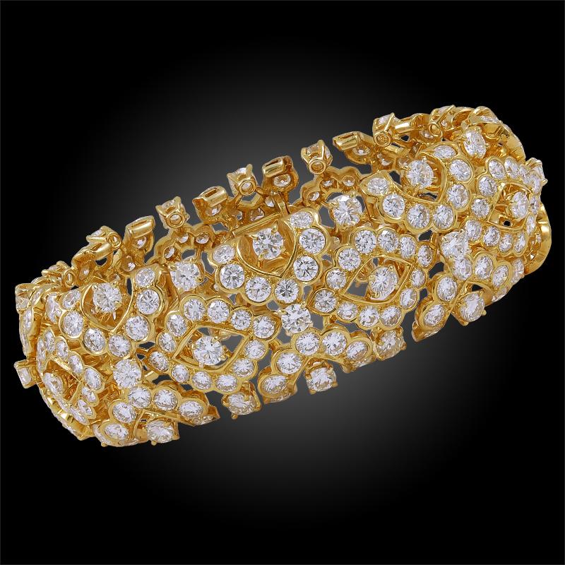 A piece that emits the quintessence of elegance and opulence, comprising a Van Cleef & Arpels diamond bangle bracelet that dates back to the 1970’s, crafted with an exquisite openwork design filled with radiant diamonds weighing approximately 40