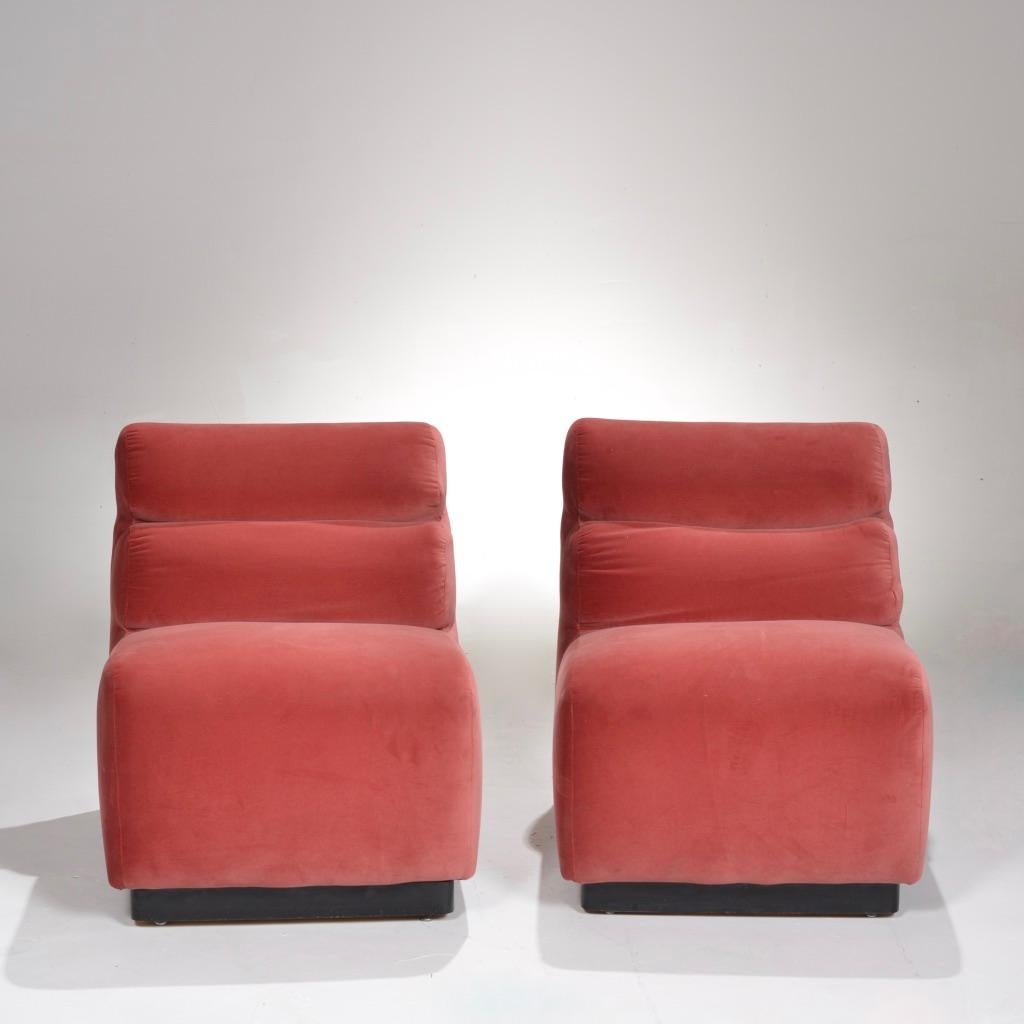 Pair of velvet slipper chairs by August Inc., 1978. Clean lines softened by subtle curves make these chairs equally sleek and plush. Great as lounge chairs or pushed together for a perfect loveseat. Newly upholstered. 

 
