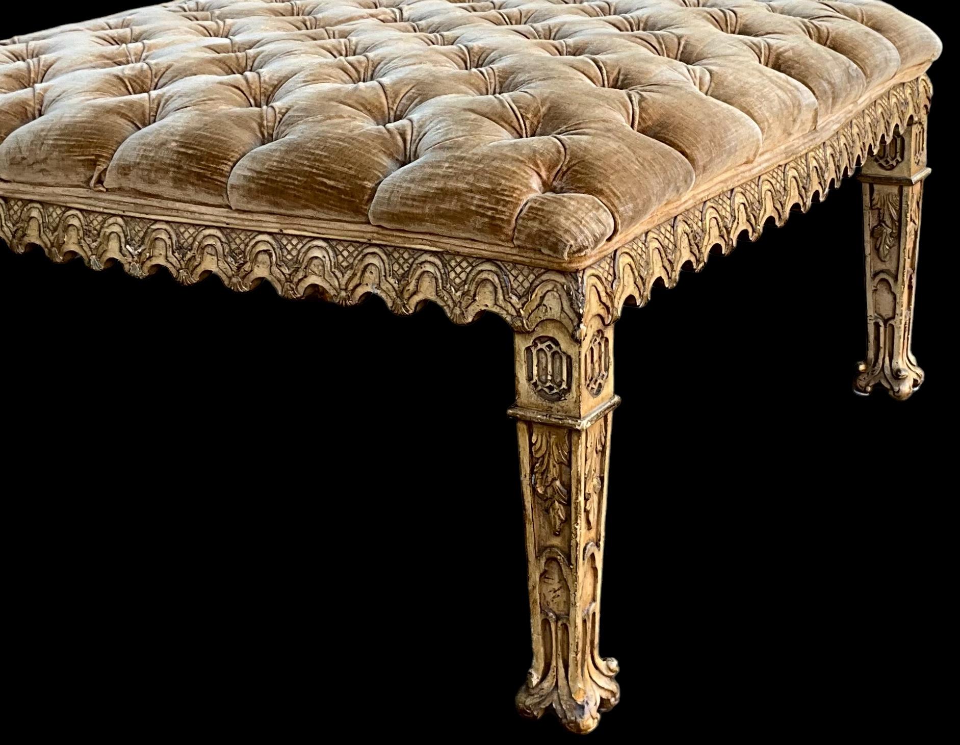This is a Venetian style heavily carved ottoman. The tufted velvet upholstery is original and shows light wear but is free from tears or stains. The piece is unmarked.