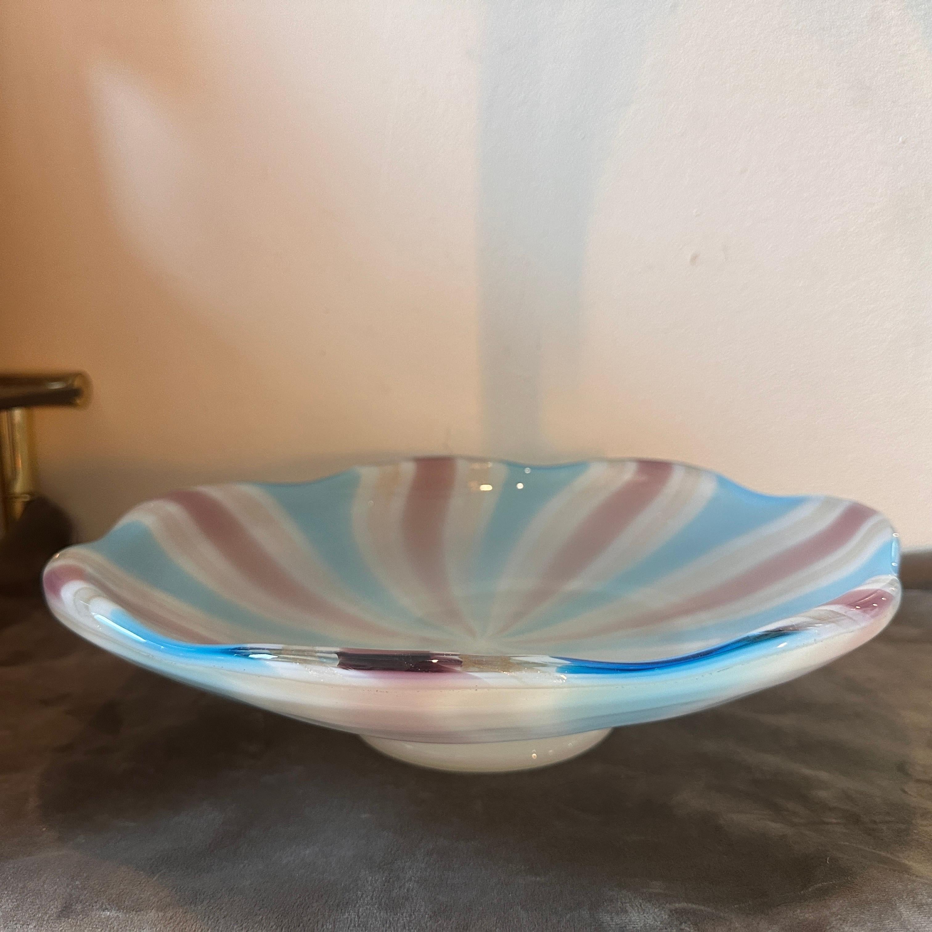 A round centerpiece designed and manufactured in Venice in the Seventies, it's in lovely condition. This bowl a beautiful and potentially valuable piece. Venini's influence on Murano glass design during that era was significant, characterized by