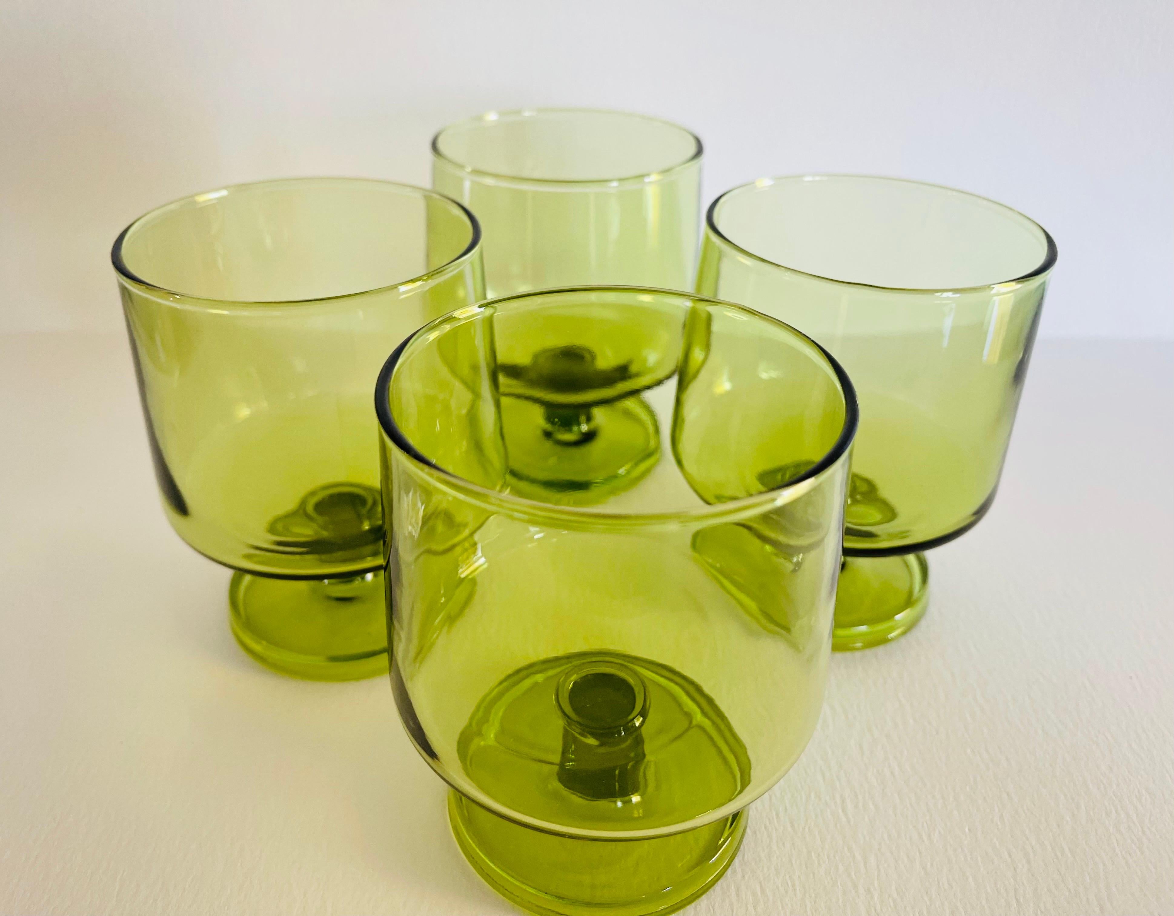 Vintage 1970s set of four footed verde green glass tumblers. No marks.