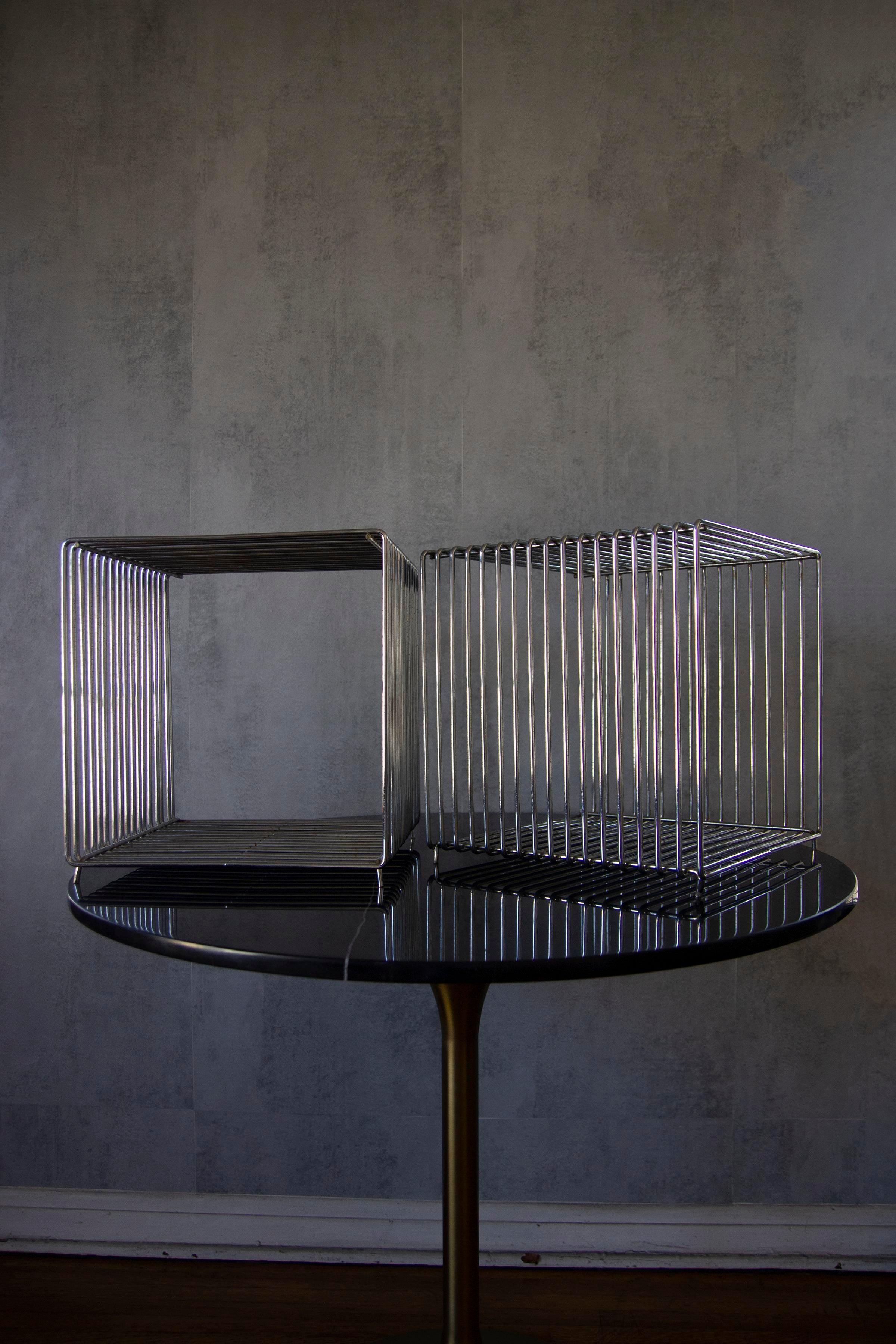 Mid-century Verner Panton Pantonova wire cube for Fritz Hansen is raw yet elegant, industrial in its design. The Panton wire units can be used individually as a stool or side table or in combination on the floor, hanging on the wall or as room