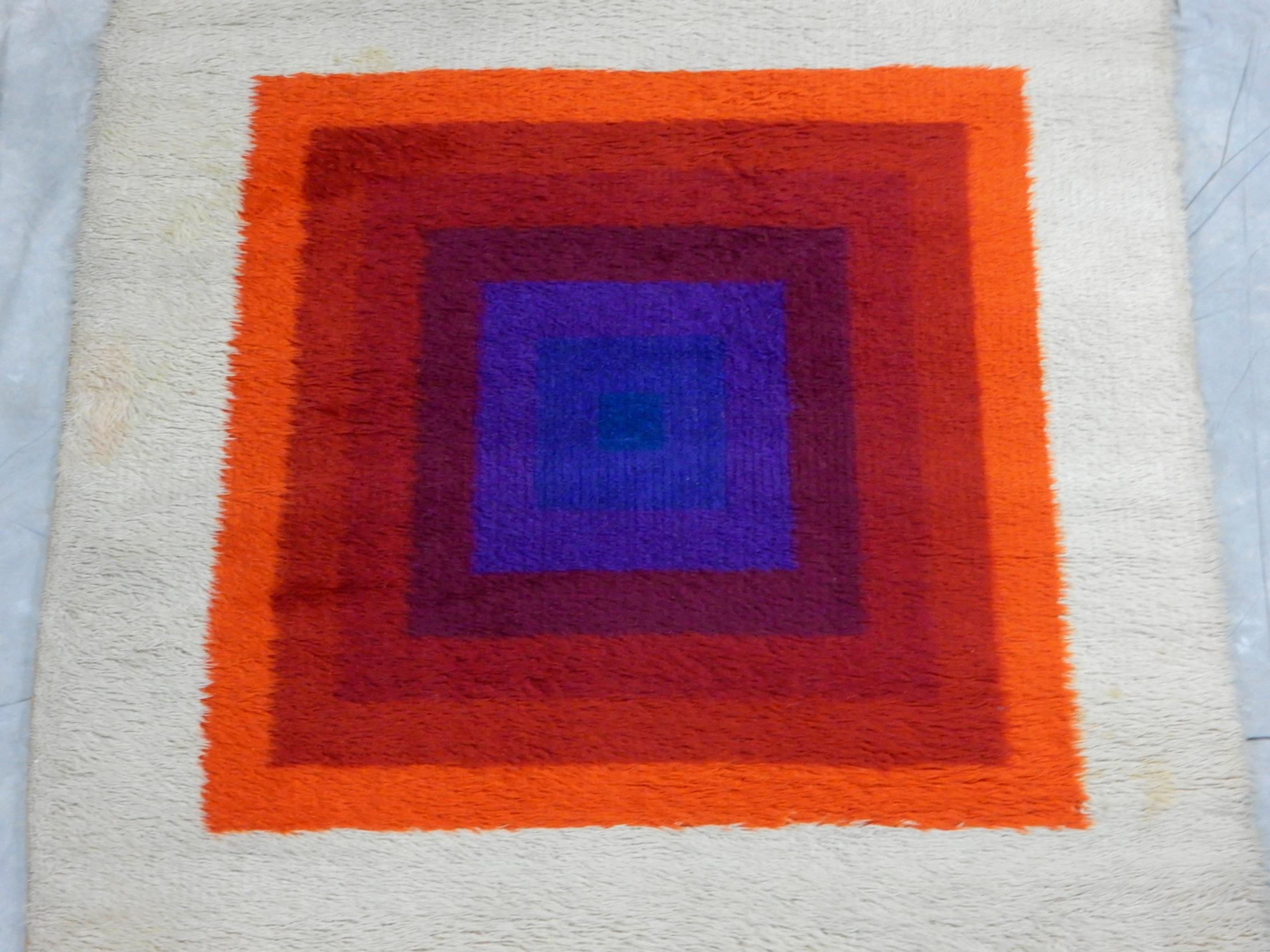 Rare original Verner Panton design 'Mira-Romantica' wool rya rug, circa 1970s.
Made in England. Colors are bold and bright.
A few light spots and soiling from use on floor. No odors.
No bald spots or damage. Measures 79in. x 54in. (6-1/2' X