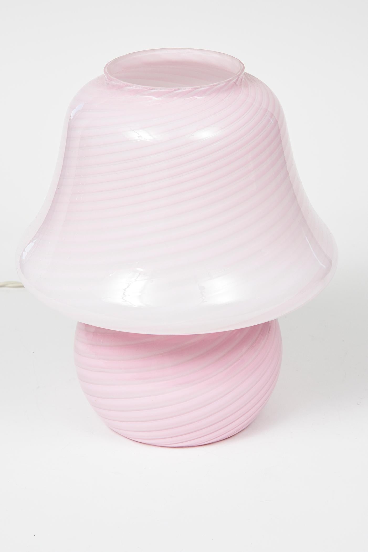 Beautiful pink Murano art glass by Vetri featuring a swirl design. A perfect example of a 1970s mushroom lamp that would look wonderful in any room. This is a small lamp which would be great on a night stand or for mood lighting. It is approximately