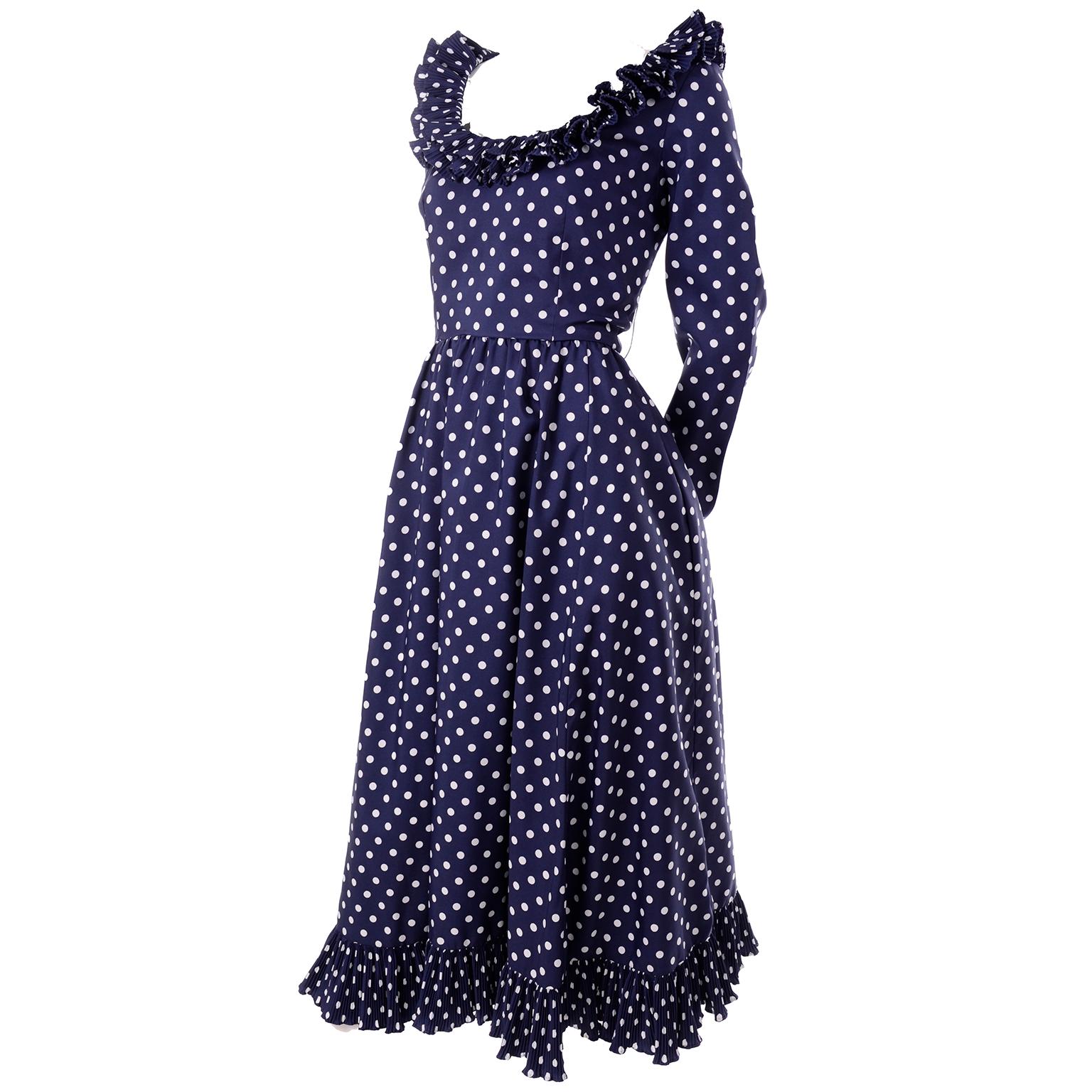 We love the playfulness of Victor Costa dresses! This late 1970's long blue maxi dress with white polka dots is no exception! It has pleated ruffles in layers around the scoop neck, and along the cuffs and hem. The full skirt hits about ankle length