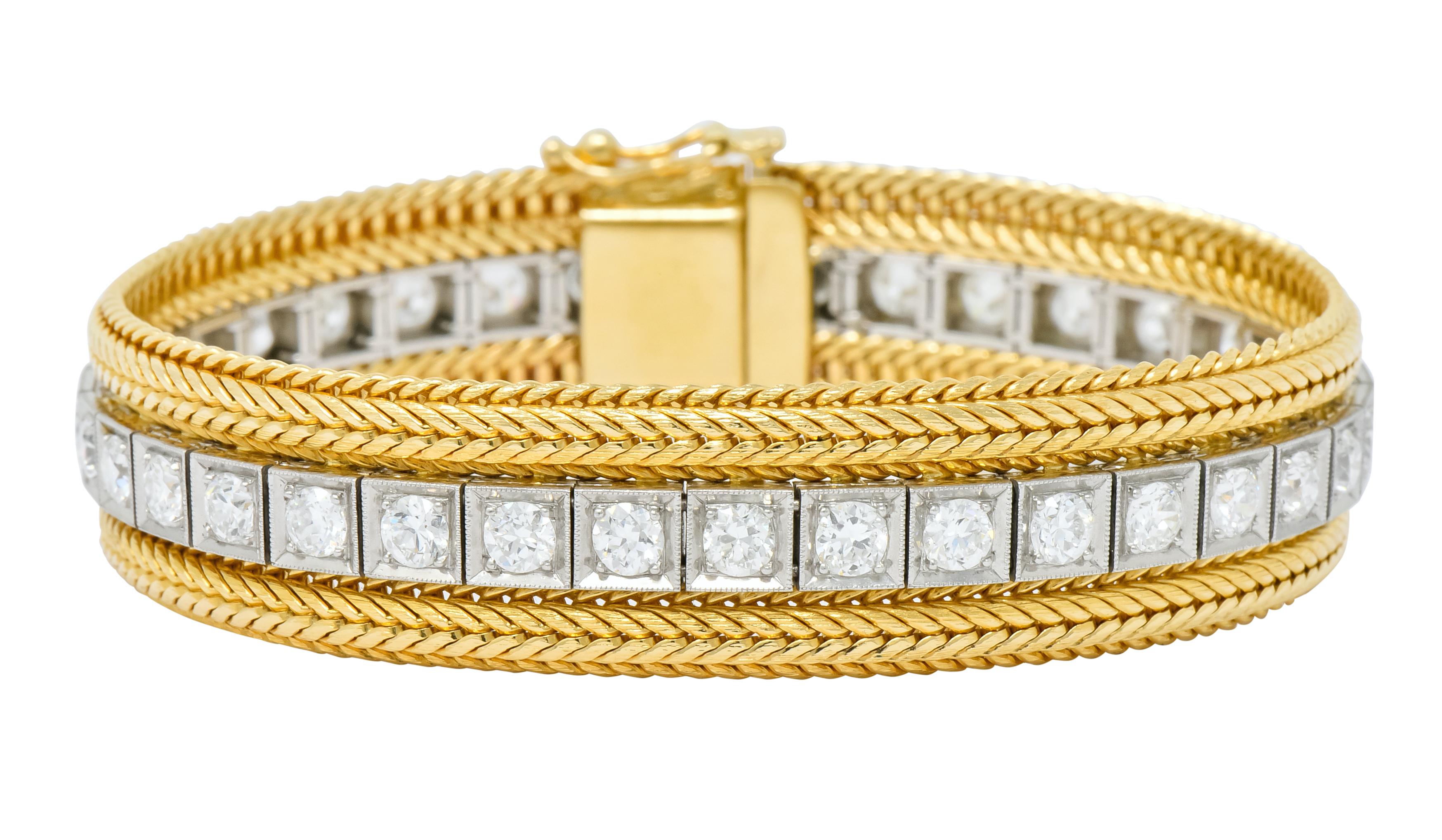 Centering a row of round brilliant cut diamonds bead set into platinum, millegrain, square form links

Diamonds weigh approximately 6.48 carats in total, G/H color and VS to SI clarity (mostly VS)

Flanked by wheat style yellow gold chain

Completed