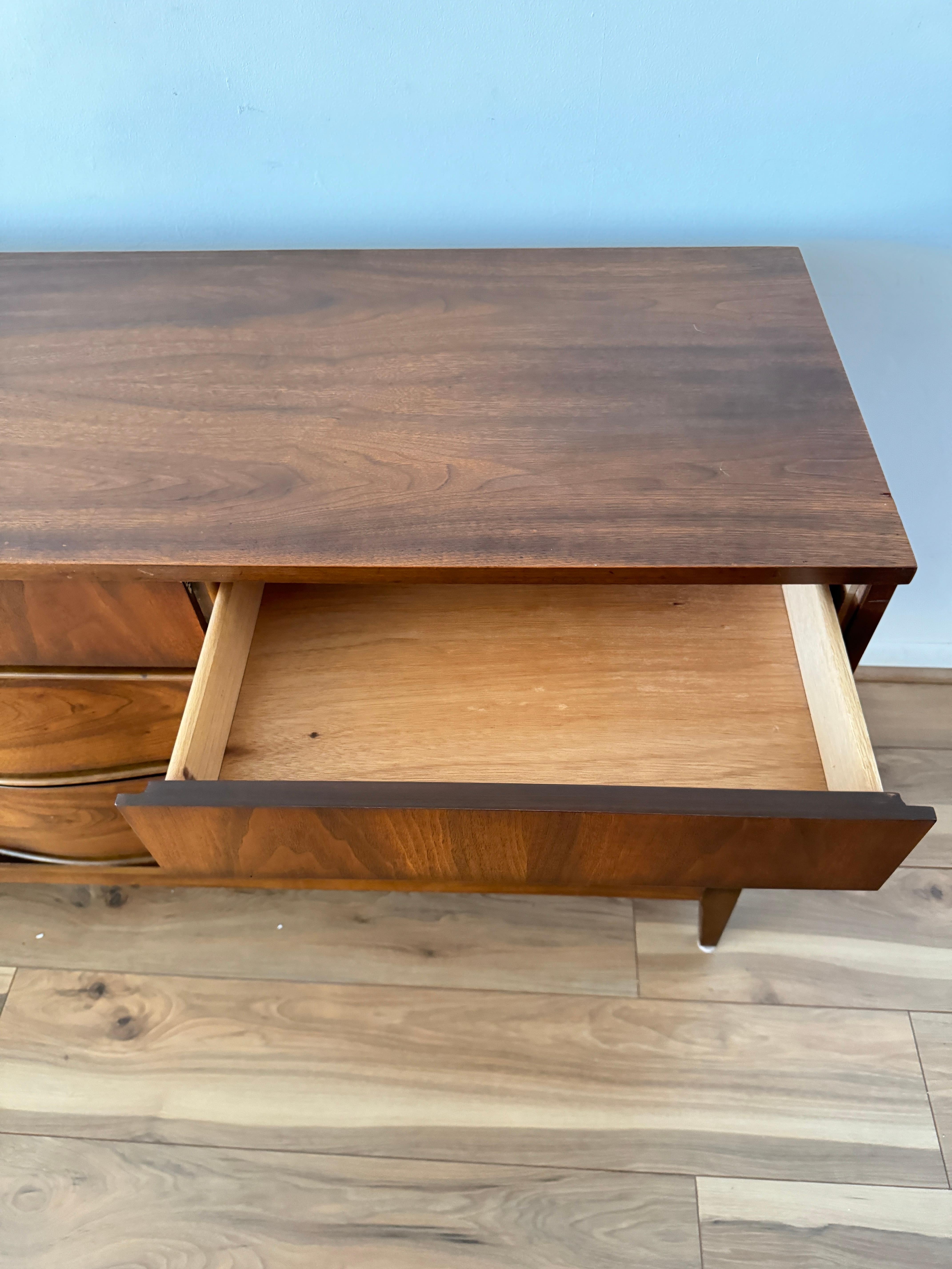 1970s Vintage 9-Drawer Walnut Lowboy Dresser Featuring an Curved Drawer Design In Good Condition In Elkton, MD