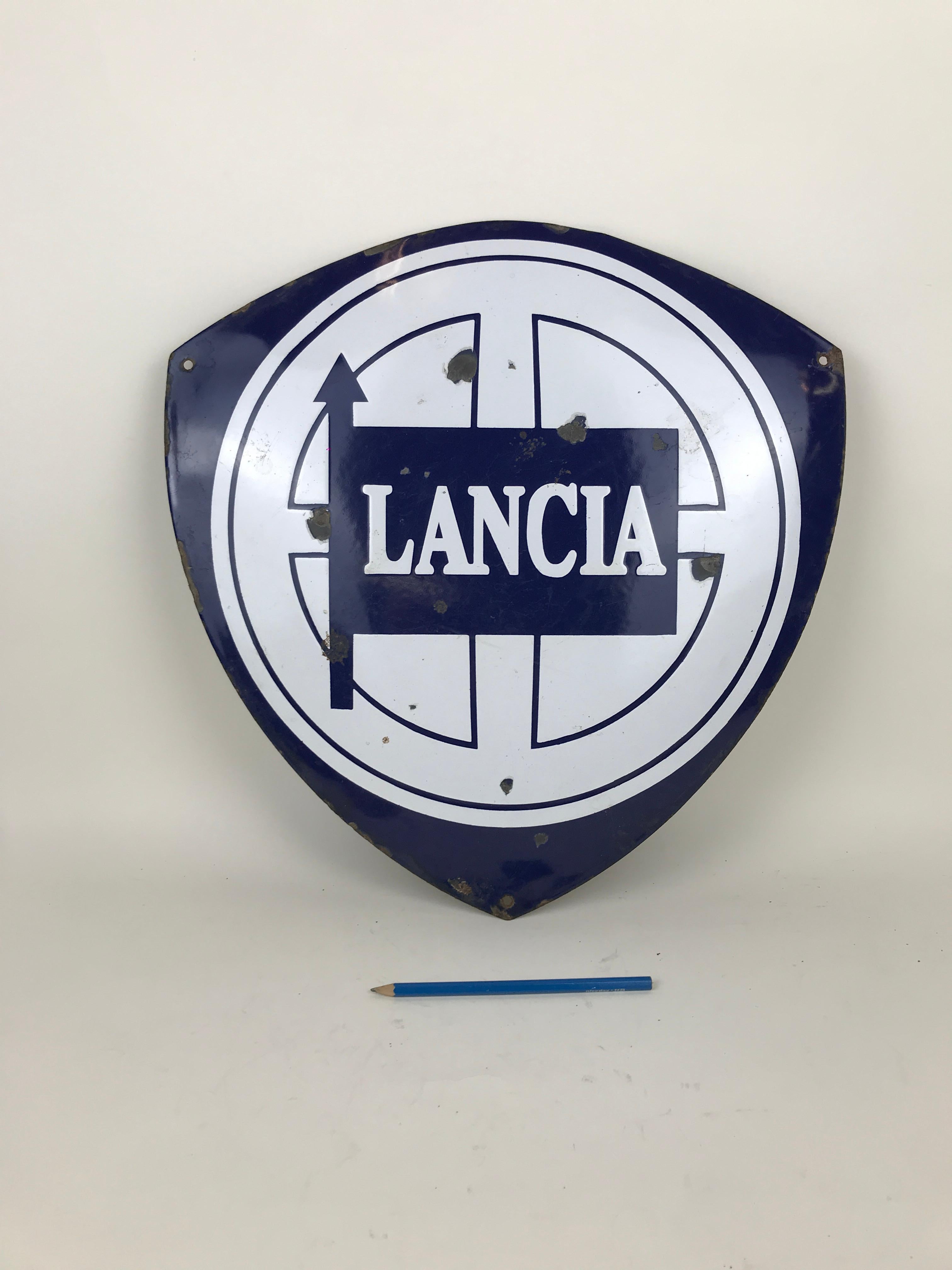 Vintage advertising enameled metal Lancia sign made in Italy in the 1970s.

Collector's note:

Lancia was an Italian automobile manufacturer founded in 1906 by Vincenzo Lancia as Lancia & C.. It became part of the fiat group in 1969; the current