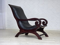 1970s, vintage armchair with footstool, black furniture leather.
