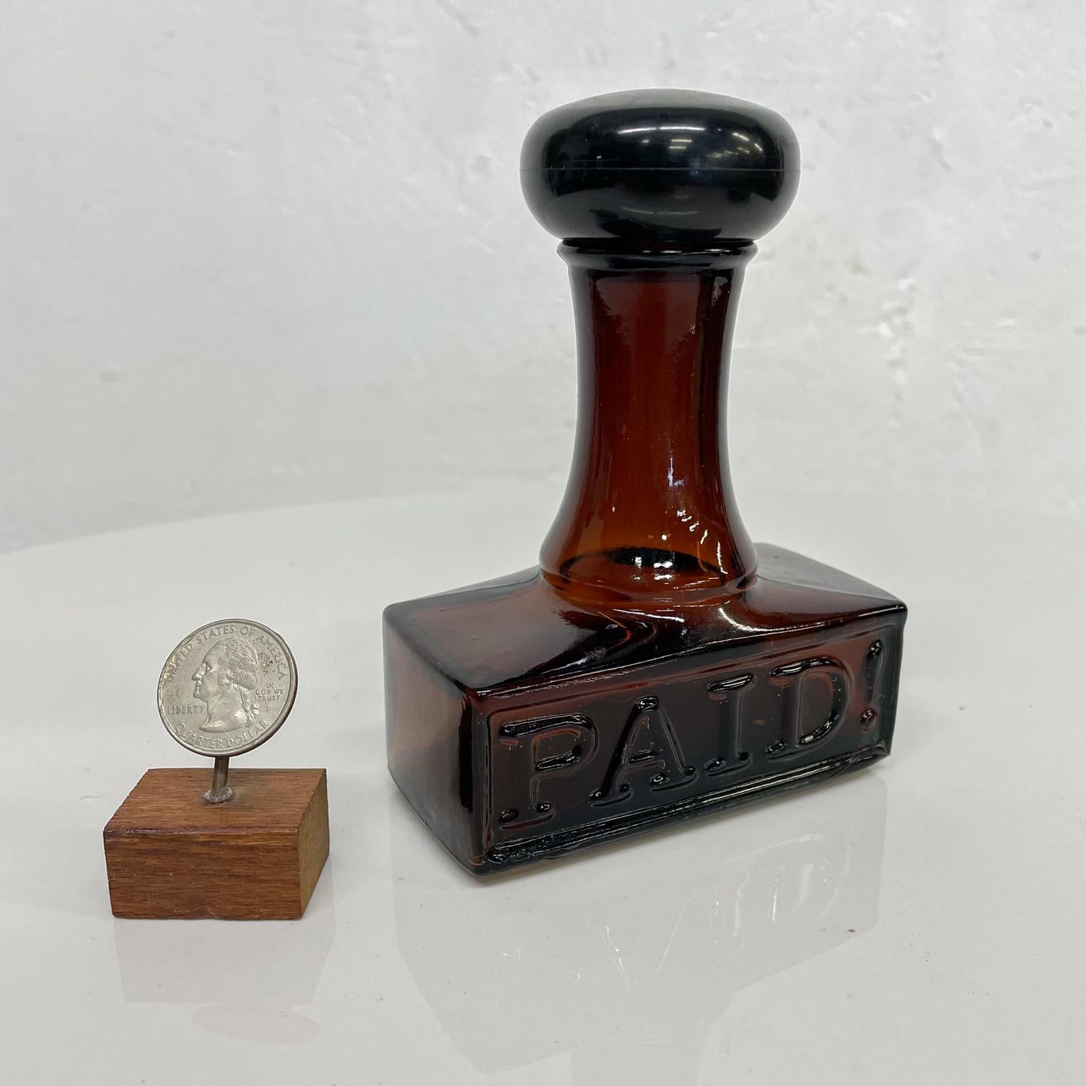 Glass Bottle PAID
Vintage Collectible Glass Perfume Decanter Cologne After Shave Bottle with Stopper in shape of a PAID Rubber Stamp marker by Avon
Measures: 4 W x 2 D x 5 H
Preowned original vintage condition.
Refer to provided images.
 