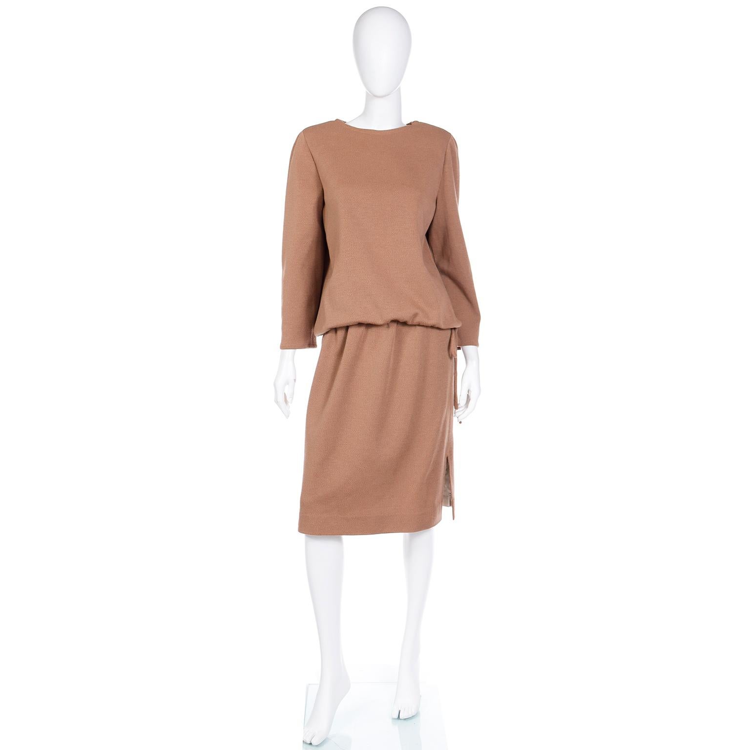 This minimalist 2 piece vintage Bill Blass outfit is in a camel colored knit and it includes a drawstring waist long sleeve top and a skirt. This vintage Bill Blass ensemble is a great alternative to a day dress and it is so easy to wear and looks
