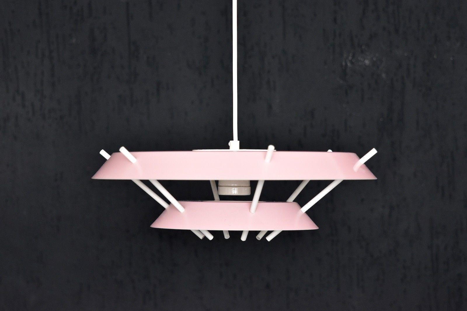 Design: bj-metal
Manufacturer: bj-metal, Made in Denmark
Typ: pendant lamp max. 60 Watt, with E26/27 Edison porcelain socket
Color: pink and white. 
 